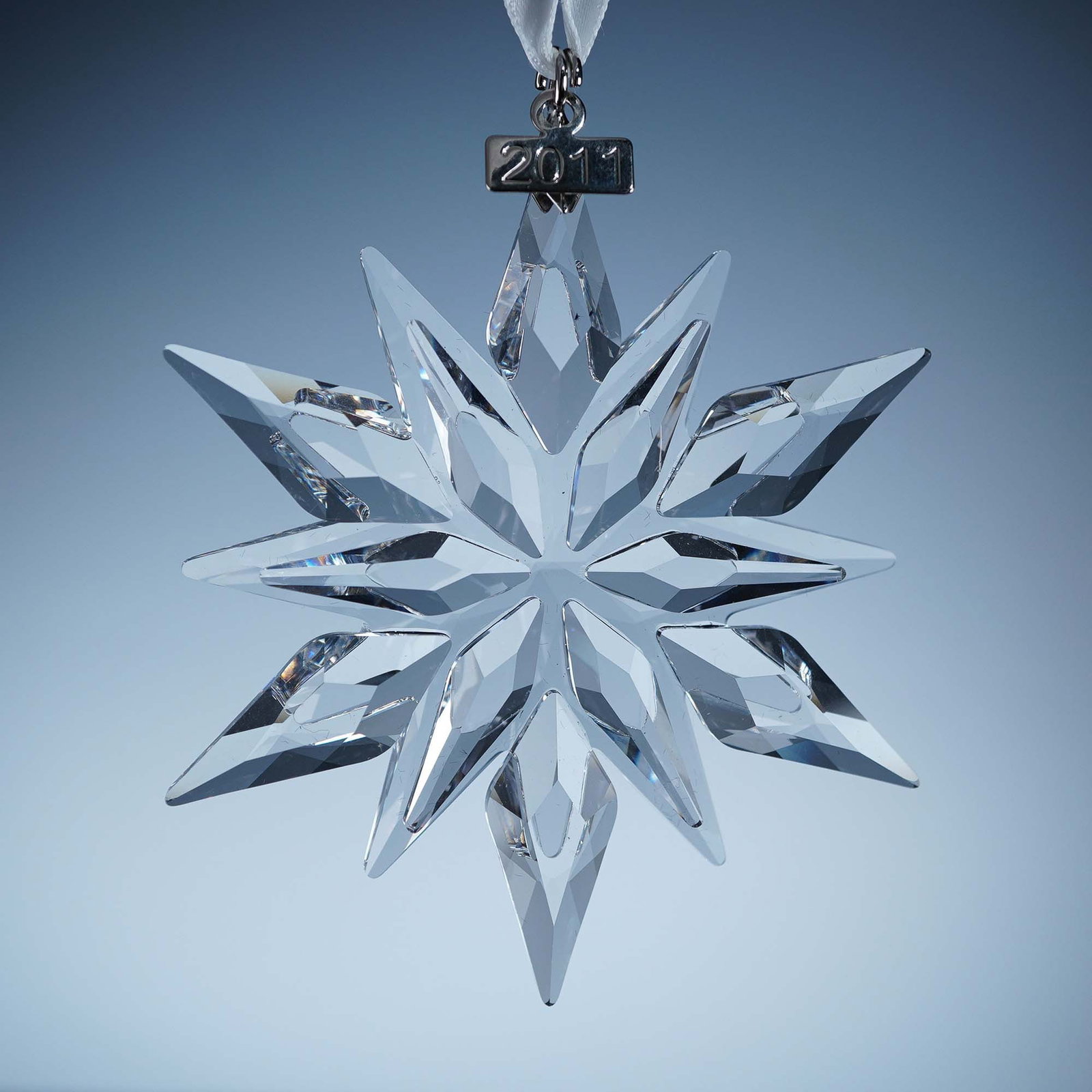 Swarovski Crystal Ornament, 2011 Christmas: This retired Swarovski 2011 Annual Edition Christmas Ornament celebrates the 20th anniversary of the iconic series. Expertly cut in clear crystal, the radiant star features 12 sparkling points and is 