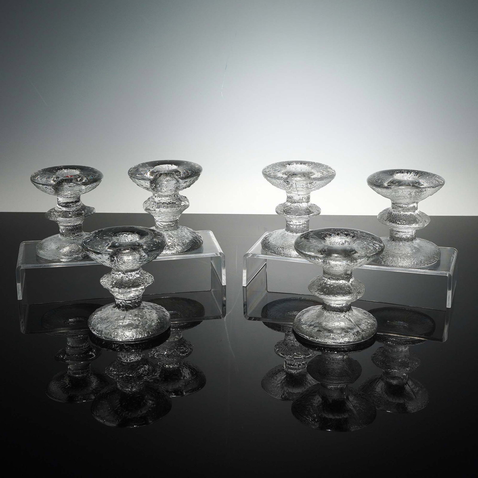 6pc Iittala Festivo Glass Candleholders: Set of six clear glass candleholders designed by Timo Sarpaneva for Iittala in the iconic Festivo pattern, known for its frosted ice-like texture and sculptural, stacked form. These Mid-Century Modern