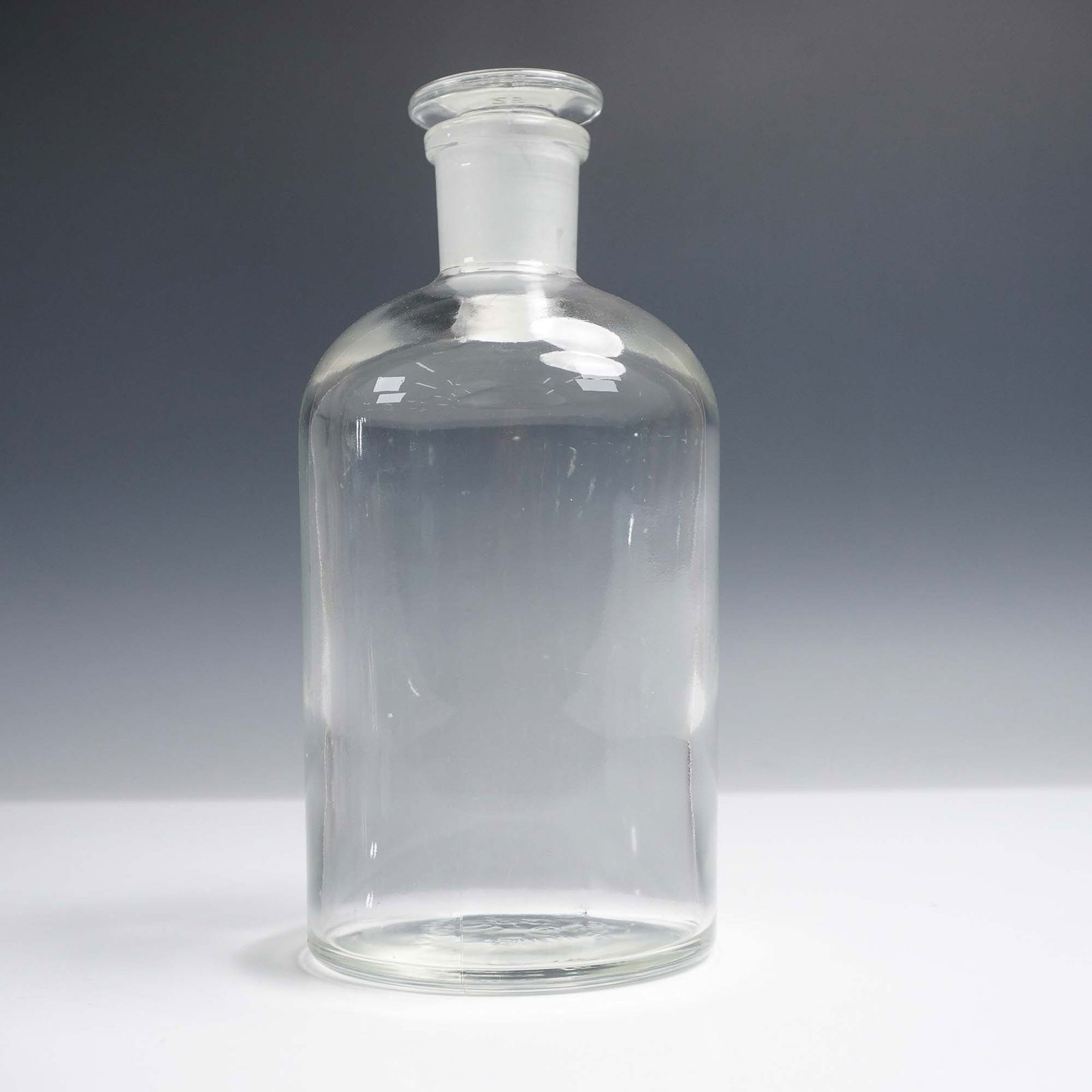 PYREX Clear Glass Bottle with Stopper: Vintage PYREX clear laboratory-style glass bottle featuring a fitted ground glass stopper marked PYREX 29. The base is embossed with the PYREX trademark, including the registered symbol and Made in US