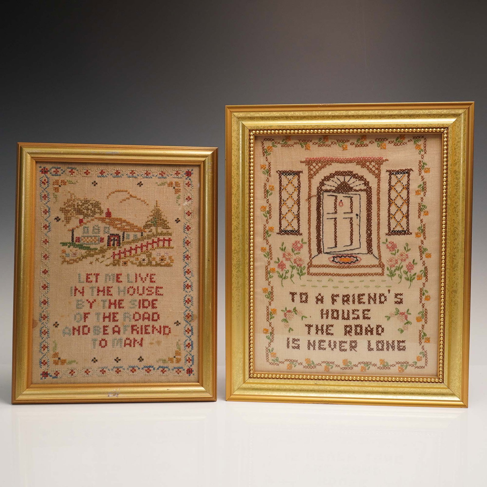 2pc Framed Needlepoint Samplers, Friendship & Home Quotes: Charming pair of vintage hand stitched needlepoint samplers, each presented in coordinating gold tone wood frames. One piece features a welcoming door flanked by lattice windows and floral borders wit