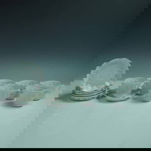 12pc Arabia Oksa Rice Grain Porcelain Cups and Saucers: A 12-piece porcelain tea set in the Oksa rice grain pattern by Arabia of Finland, designed by Friedl Holzer-Kjellberg. This refined mid-century set includes six cups and six matching saucers, each sho