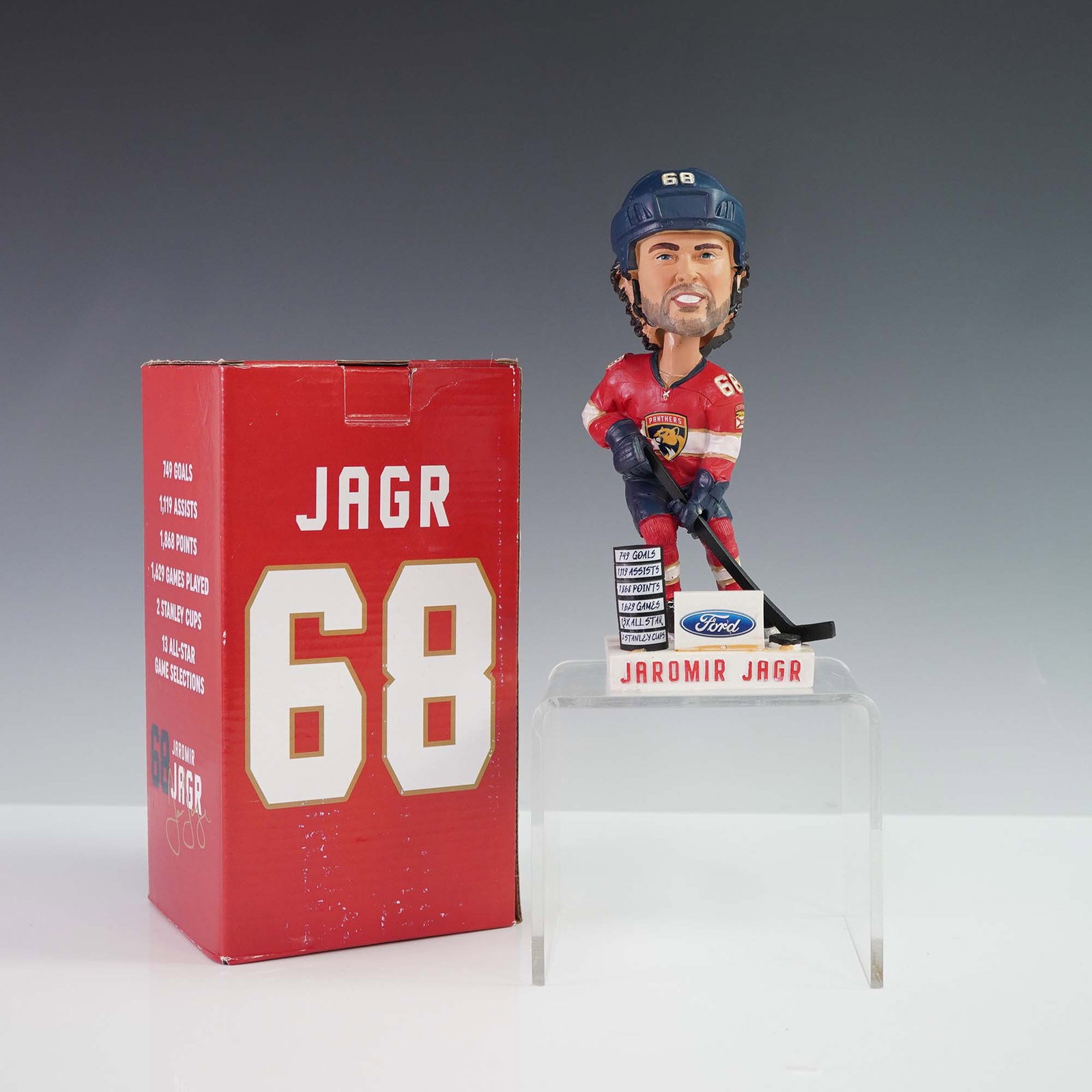 Jaromir Jagr #68 Florida Panthers Bobblehead with Box: Official Florida Panthers bobblehead commemorating NHL icon Jaromir Jagr, wearing jersey number 68. Features Jagr in a red Panthers uniform atop a stat-covered base, with a printed facsimile signature