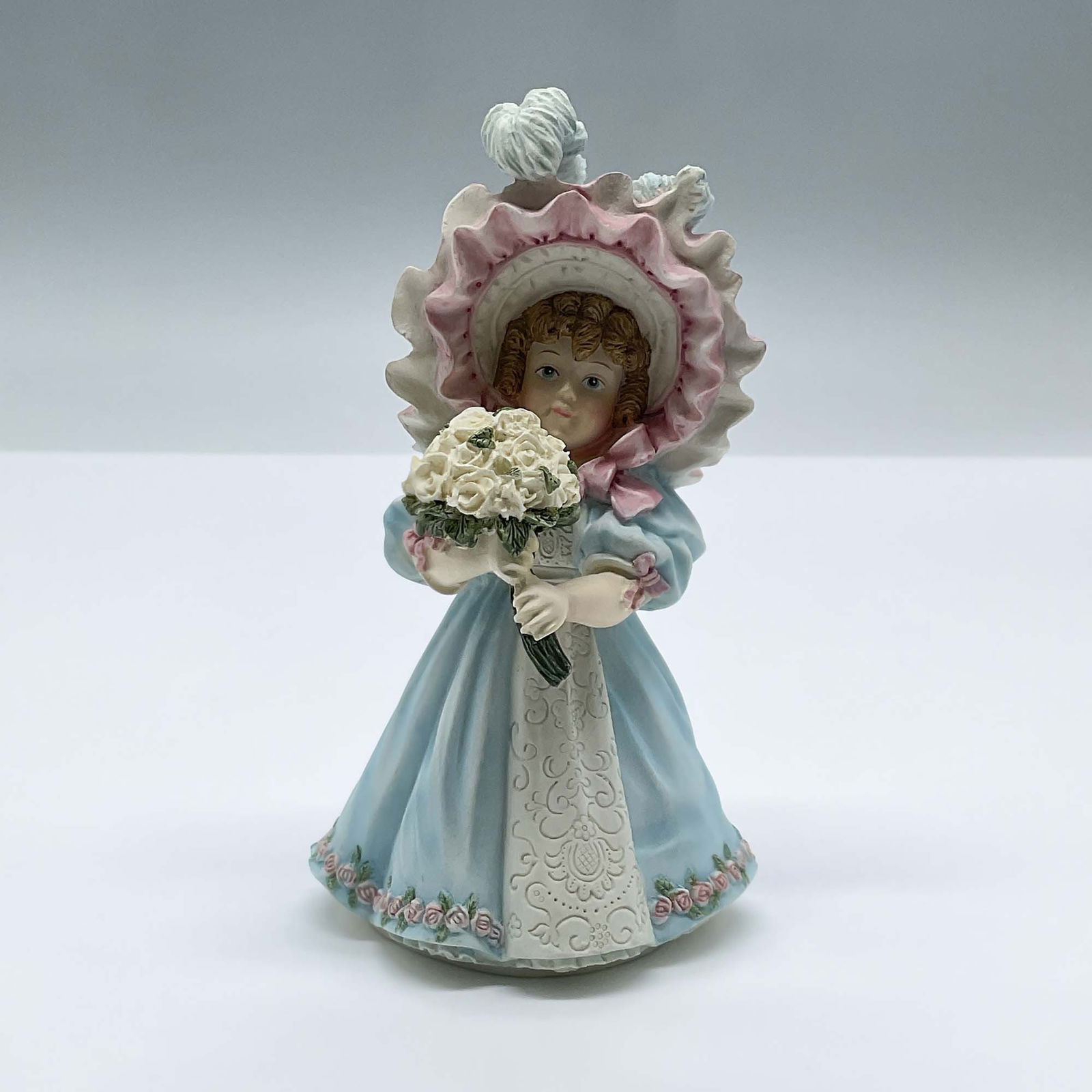 Enesco Porcelain Event Figurine, Love To Last A Lifetime: Features a lovely limited edition bisque porcelain figure of a small girl dressed in blue with a feathered head piece, holding a bouquet of white roses. Maud Humphrey Bogart by Enesco backstamp. 65562