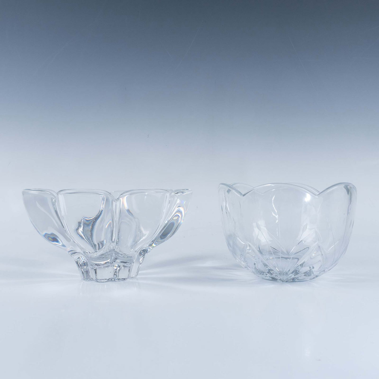2pc Clear Crystal Flower Shaped Bowls: A set of crystal decorative bowls with a beautiful flower design, offering a sophisticated and charming aesthetic. Each bowl dimensions: 4.75"W x 3.5"H and 6"W x 3.5"H. Dimensions: See Description