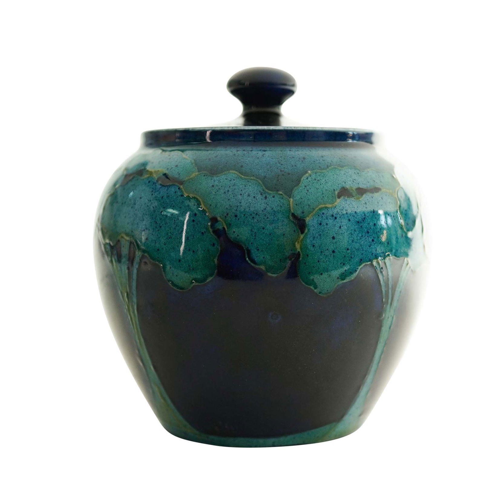 William Moorcroft 'Moonlit Blue' Tobacco Jar and Cover, c. 1925: Moonlit Blue tobacco jar and cover, circa 1925. Glazed earthenware, decorated with tube-lined landscape design. Painted W.M. monogram, with impressed "Moorcroft" and "Made In England". Artist: William
