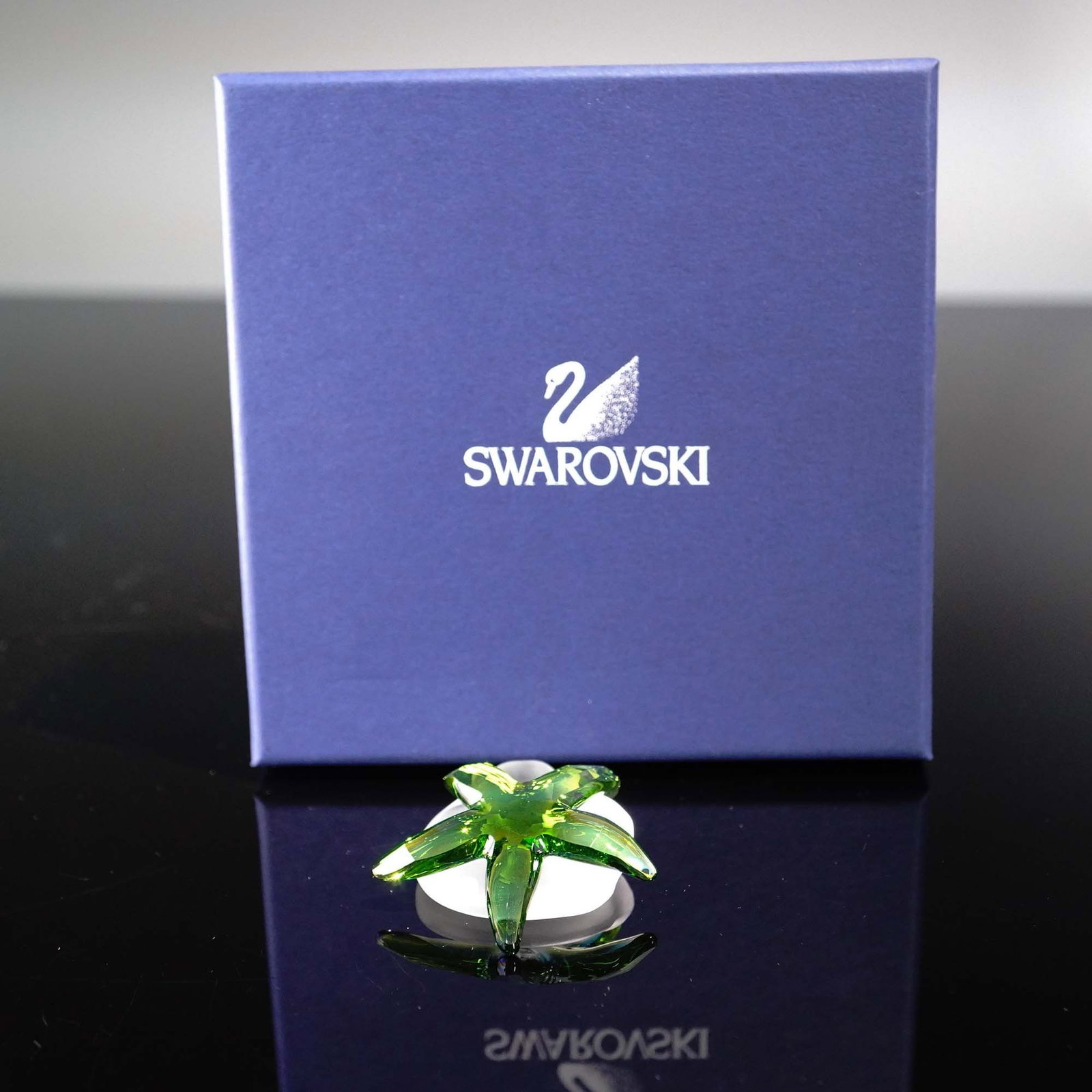 Swarovski Crystal Paradise Cantillana Starfish: A vibrant Swarovski Crystal Paradise Cantillana Starfish, crafted in stunning green crystal with exceptional brilliance and precision-cut facets. This collectible figure depicts a tropical starfish, p
