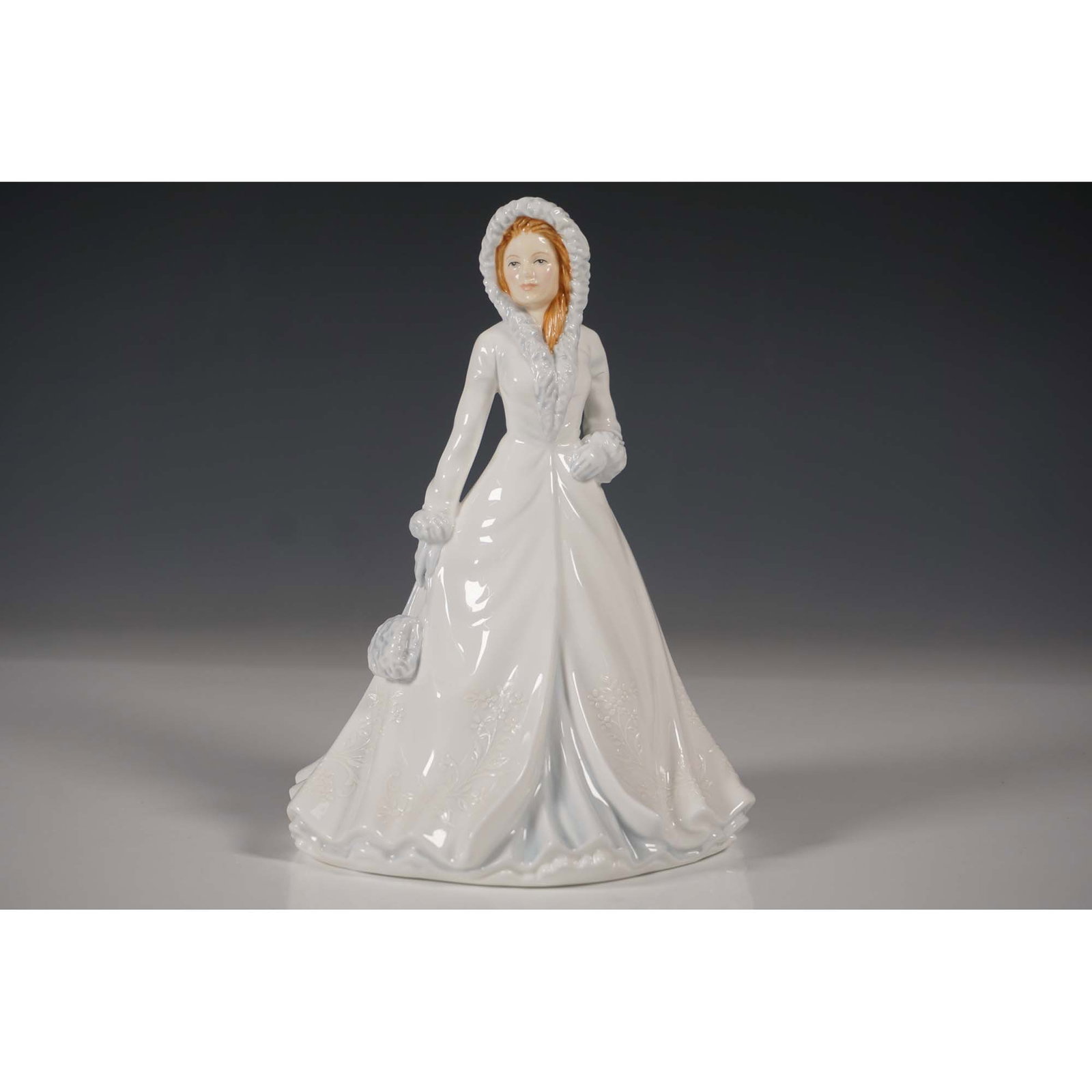 Royal Doulton Figurine, White Christmas HN5608: Royal Doulton presents White Christmas, a beautifully hand-decorated bone china figurine from the Songs of Christmas series. Designed with intricate detailing, this elegant piece depicts a young woman