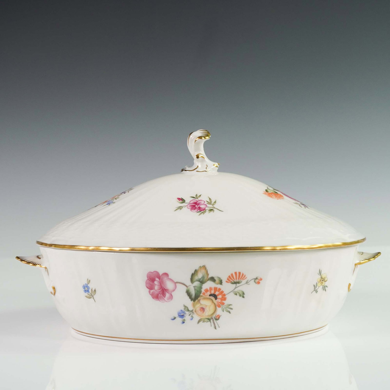 Royal Copenhagen Frijsenborg Lidded Tureen: Royal Copenhagen porcelain lidded tureen from the Frijsenborg series featuring hand-painted floral sprays on a white ground with scalloped details and gold trim. The elegant design includes delicately