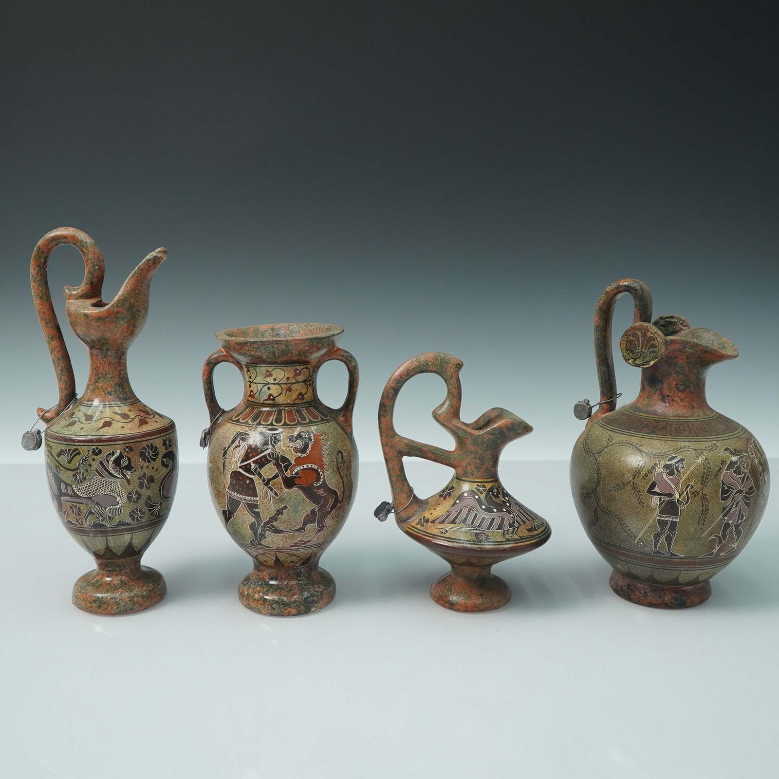 4pc Greek Style Pottery Vessels: Group of four hand made Greek-style pottery vessels inspired by ancient Corinthian and Attic designs. Includes a prochous marked as Corinthian Art circa 640 B.C. and an amphora inscribed as Attic Amph