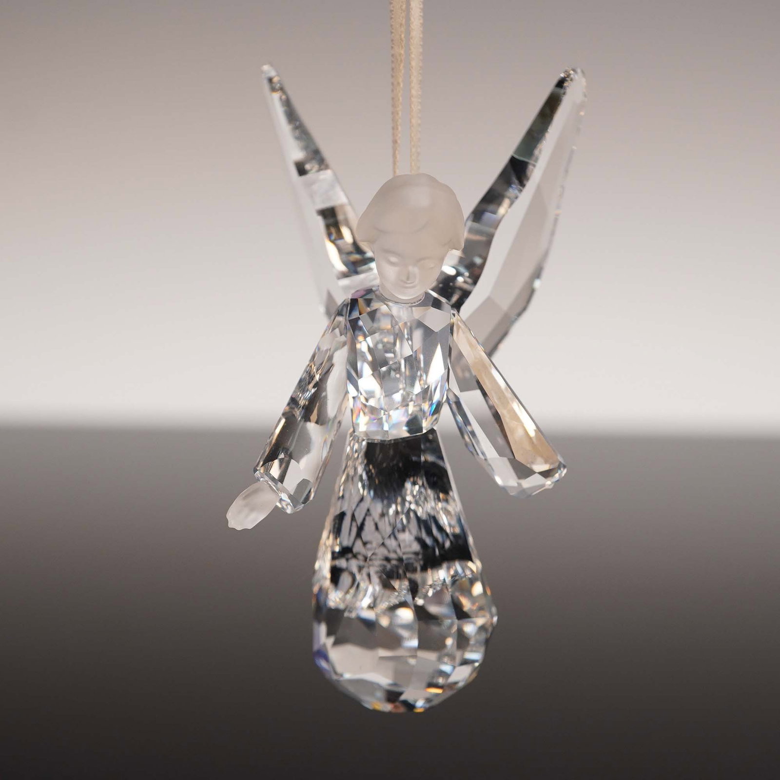 Swarovski Crystal Figurine, Angel Ornament 2008: This sparkling Swarovski angel ornament was introduced in 2008 and features a delicate blend of clear and matt crystal elements. Designed by Elke Huber, the figurine presents a serene angel with outst