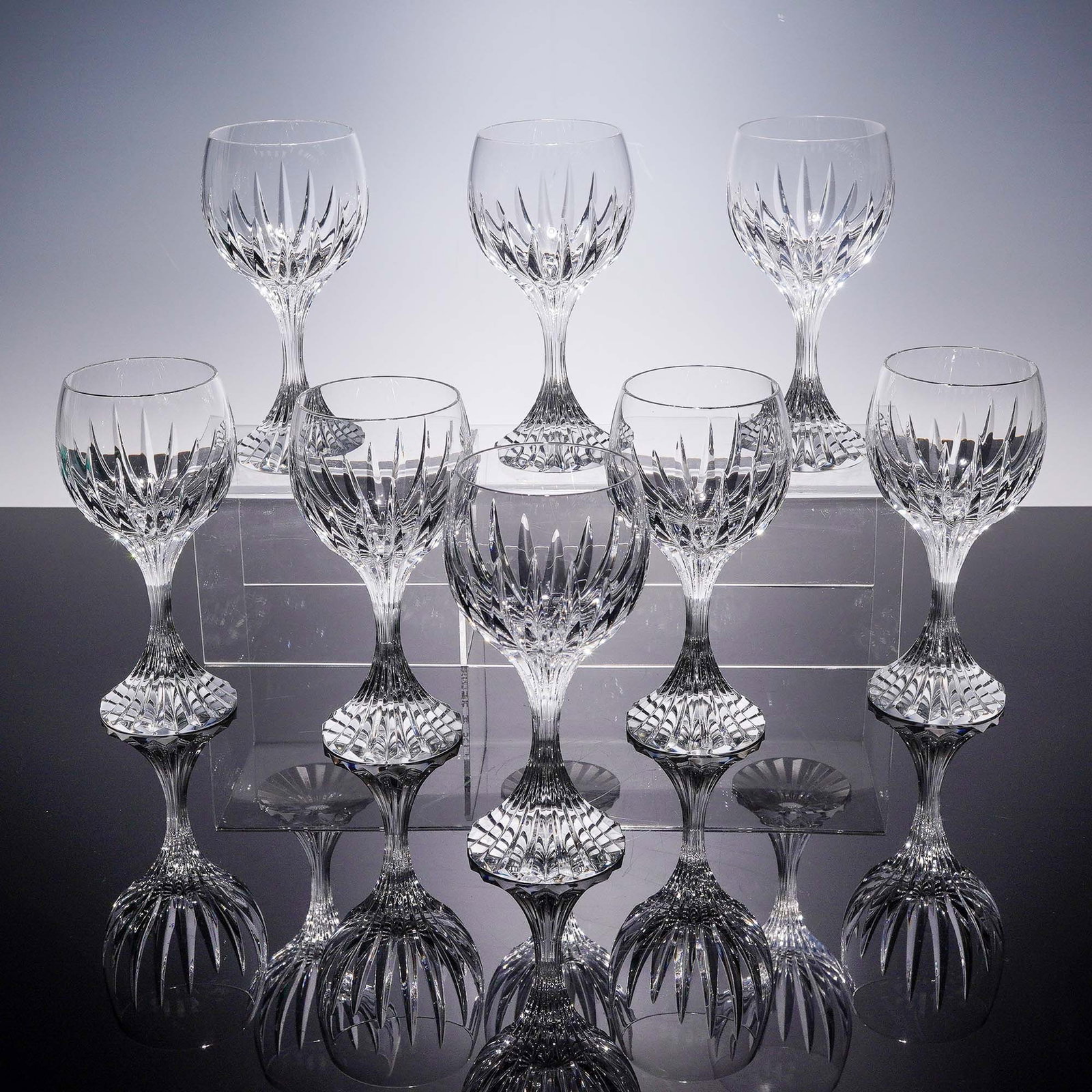 8pc Baccarat Crystal Wine Glasses, Massena: This 8-piece set of wine glasses by Baccarat Crystal features the distinguished Massena pattern, celebrated for its deep bevel cuts and radiant clarity. Each glass stands approximately 6.5"H and is ex