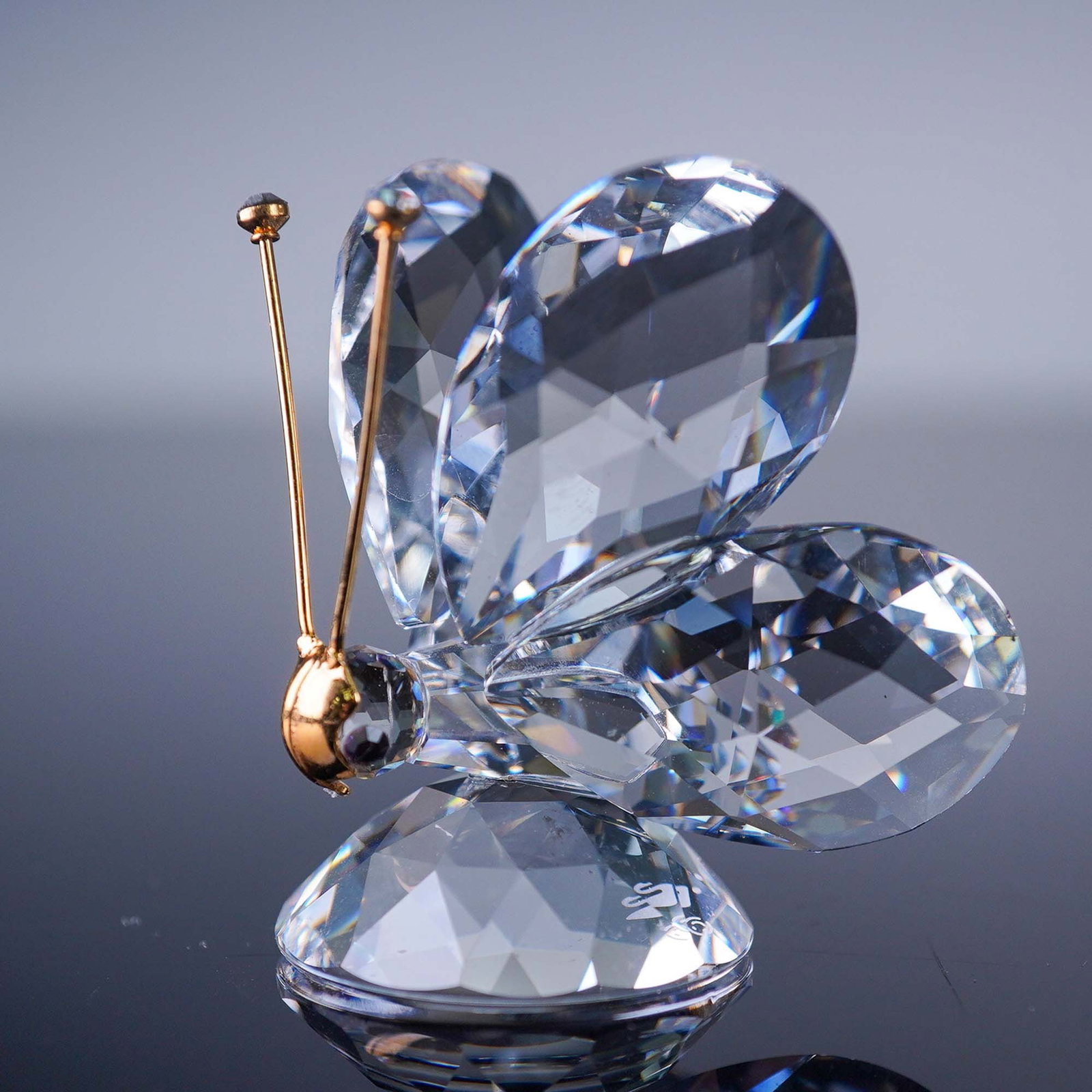 Swarovski Crystal Figurine, Butterfly: This Swarovski Silver Crystal butterfly figurine showcases precision-cut clear crystal wings accented by a golden metal body and antennae, reflecting Swarovski's renowned craftsmanship and design eleg