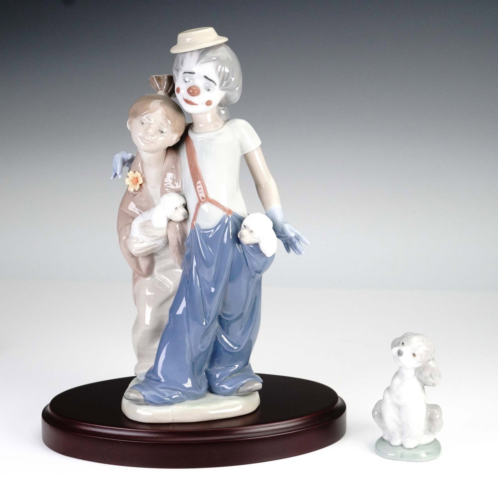 Lladro Porcelain Figurines, Pals Forever 7686 and A Friend for Life 7685: This charming Lladro figurine set includes Pals Forever (7686) and A Friend for Life (7685), both crafted in high gloss porcelain. Pals Forever depicts a joyful clown couple walking arm in arm with tw