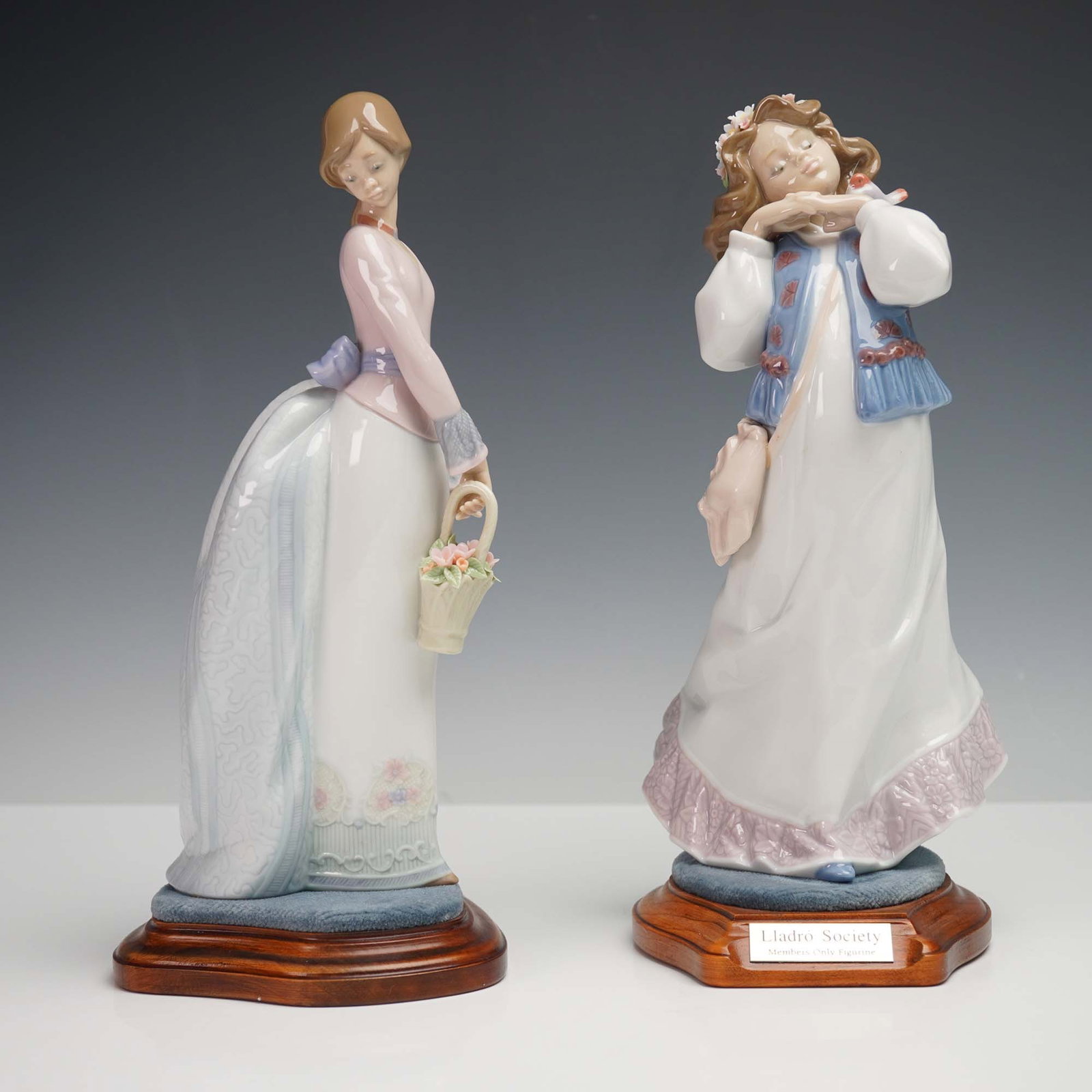 Lladro Porcelain Figurines, Dreams of a Summer Past and Basket of Love: This 2-piece set of Lladro porcelain figurines includes Dreams of a Summer Past (item 01006401) and Basket of Love (item 01007622), each capturing the delicate grace and charm of youthful femininity. 