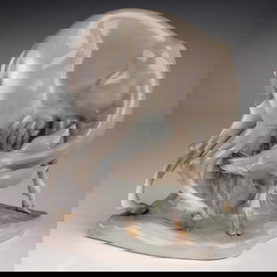 Lladro Porcelain Figurine, Grazing Gazelle 01000327.13: This early and very rare Lladro porcelain figurine features a stylized gazelle bending down to graze, its elongated form and arched pose accentuated by the soft gloss of taupe and ivory glazes. Mounte