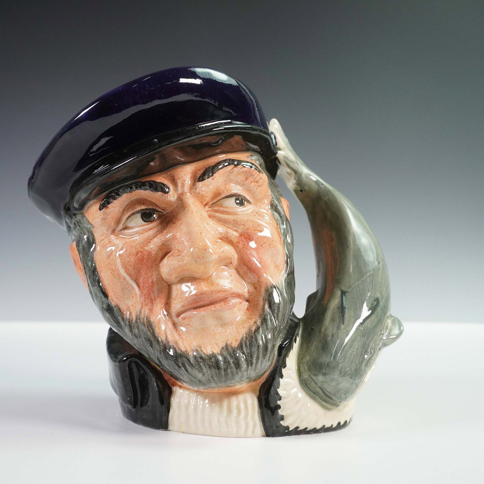 Royal Doulton Large Character Jug, Capt Ahab D6500: Royal Doulton character jug depicting Captain Ahab, the iconic whaling captain from Moby Dick, model D6500. Sculpted in rich tones with a detailed expression and a whale-form handle, this expressive j