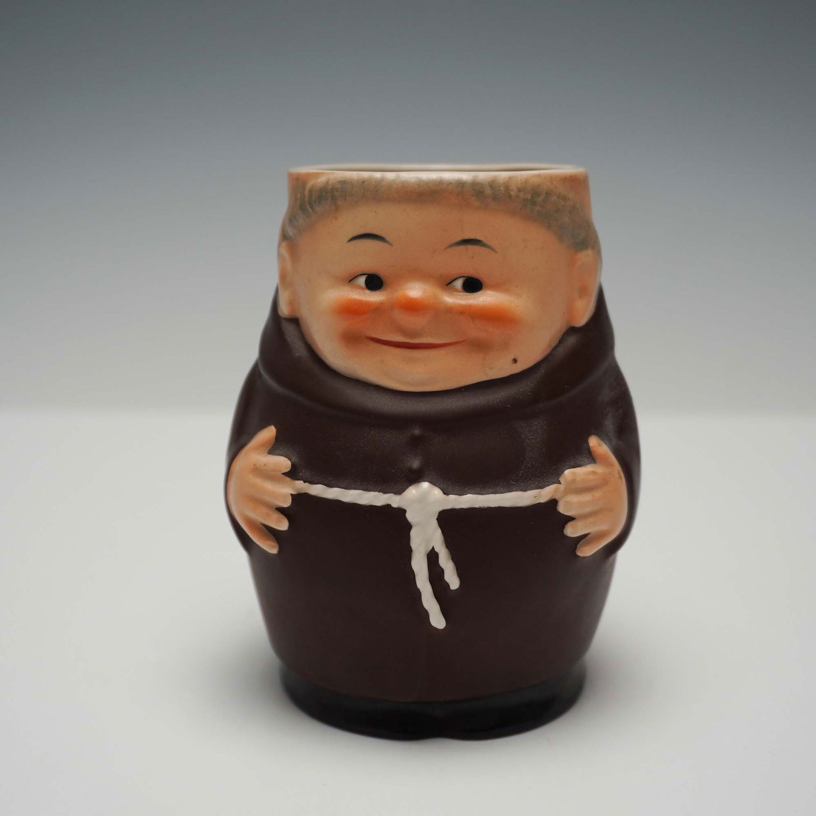 Goebel Hummel Porcelain Toby Jug, Friar Tuck: Charming Goebel Hummel porcelain toby jug featuring the iconic Friar Tuck design. Crafted in Western Germany, this collectible piece showcases a jovial friar dressed in traditional brown robes. The ex