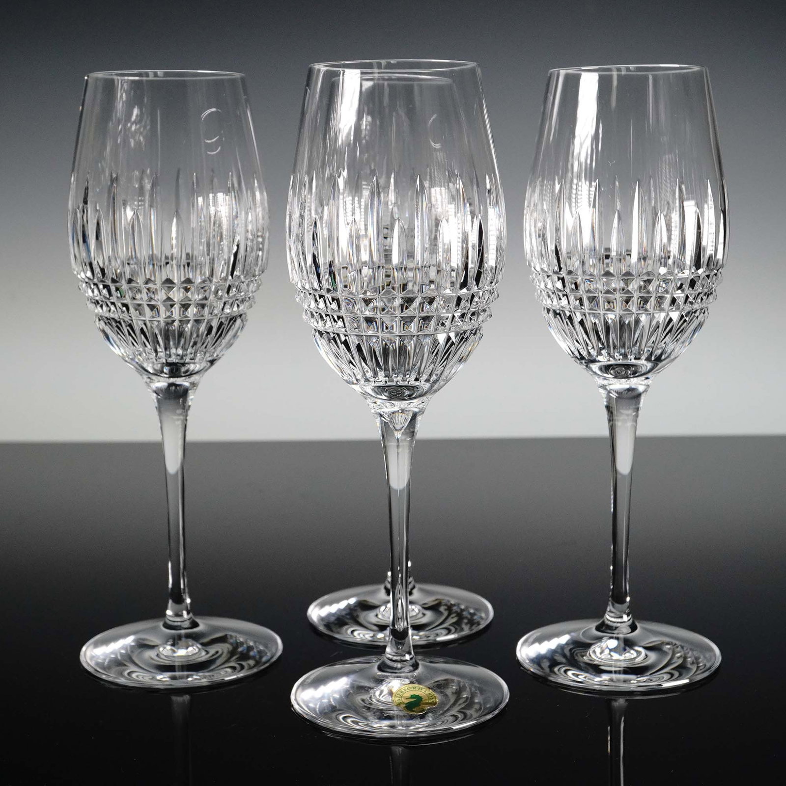 4pc Waterford Crystal Wine Glasses, Lismore Pattern: This elegant 4-piece set of Waterford crystal wine glasses features the iconic Lismore pattern, distinguished by its signature combination of wedge and diamond cuts that radiate brilliance and clarity