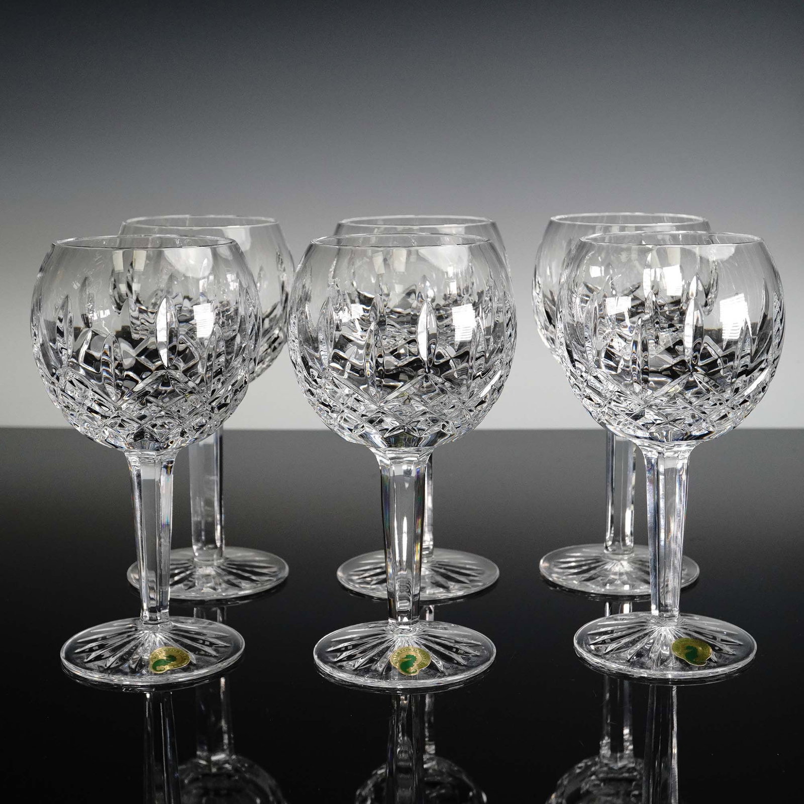 6pc Waterford Crystal Lismore Balloon Wine Glass Set: This elegant 6-piece set of Waterford Crystal balloon wine glasses features the iconic Lismore pattern, characterized by its brilliant diamond and wedge cuts and perfectly balanced stems. Each glass s