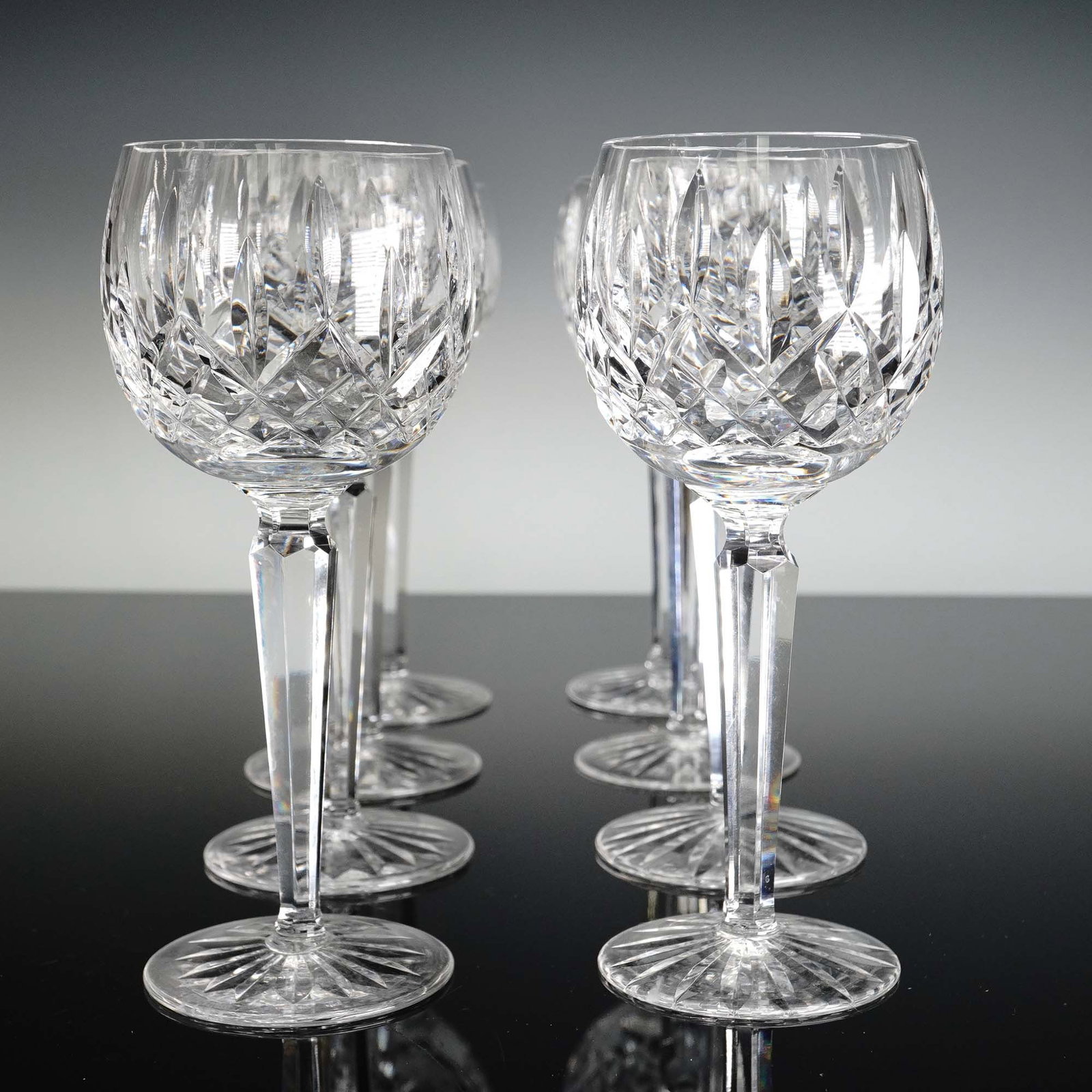 8pc Waterford Crystal Hock Wine Glasses, Lismore: Waterford's iconic Lismore pattern, introduced in 1952 and inspired by Ireland's rugged coastline, features expertly hand-cut diamond and wedge facets that catch and refract light for exceptional bril