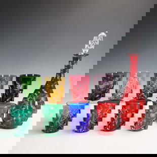 9pc Cut to Clear Crystal Tumblers and Decanter Set: Elegant 10-piece cut to clear crystal barware set featuring a red decanter with faceted stopper and eight multi-colored tumblers in vivid hues like cobalt, emerald, and amethyst. Each piece is decorat