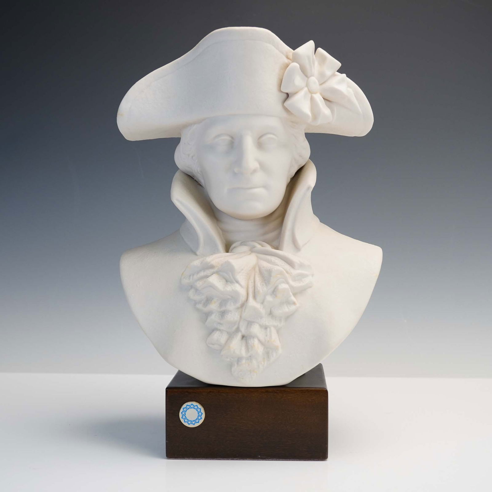Cybis Porcelain Bust of George Washington: This finely sculpted Cybis porcelain bust depicts George Washington in a classical Neoclassical style, dressed in an 18th-century military uniform with ruffled cravat and cocked hat adorned with a ros