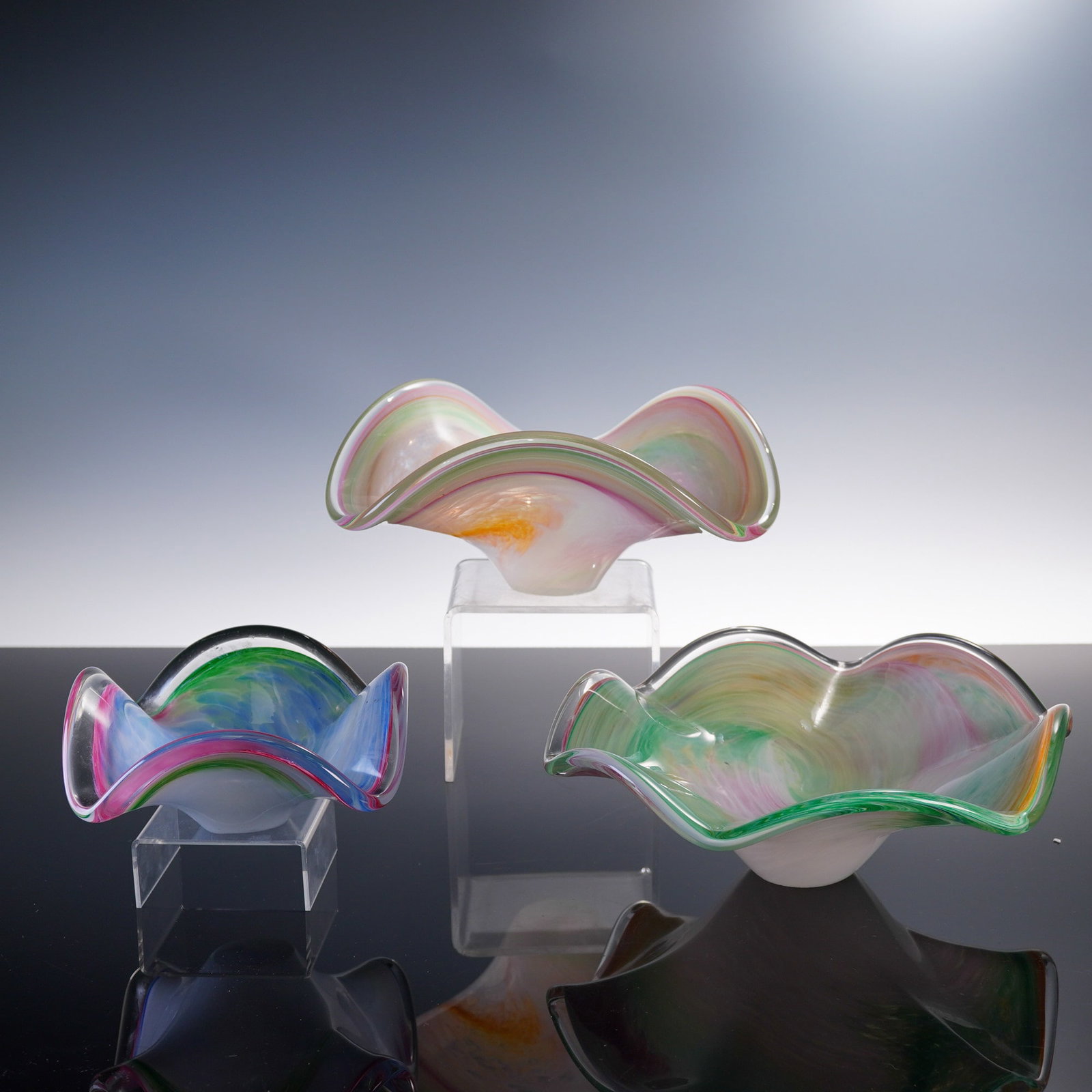 3pc Art Glass Bowls With Freeform Rims, Swirled Pastel Colors: A group of three hand-blown art glass bowls, each featuring vibrant swirls of pastel hues including pink, green, orange, purple, and blue, with distinctive freeform ruffled rims. The pieces exhibit un