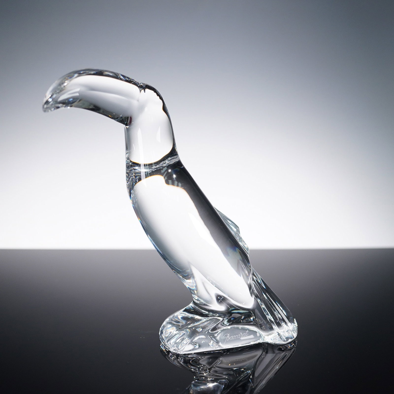Baccarat Clear Crystal Figurine, Toucan: This elegant Baccarat clear crystal figurine captures the bold and distinctive silhouette of a toucan with sleek, stylized form and graceful curves. Produced by the renowned French crystal maker Bacca