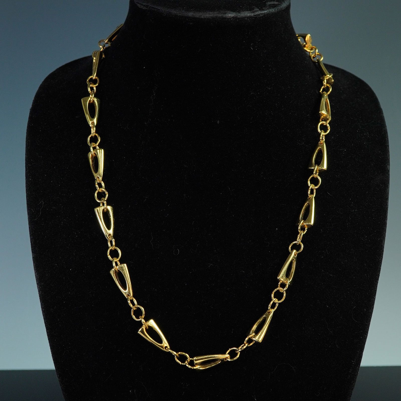 Trifari Mid-Century Modern Necklace: Vintage Trifari necklace in gold tone finish, measuring approximately 24 inches long. Features a distinctive link design characteristic of the brand's mid-century modern aesthetic. The necklace showca