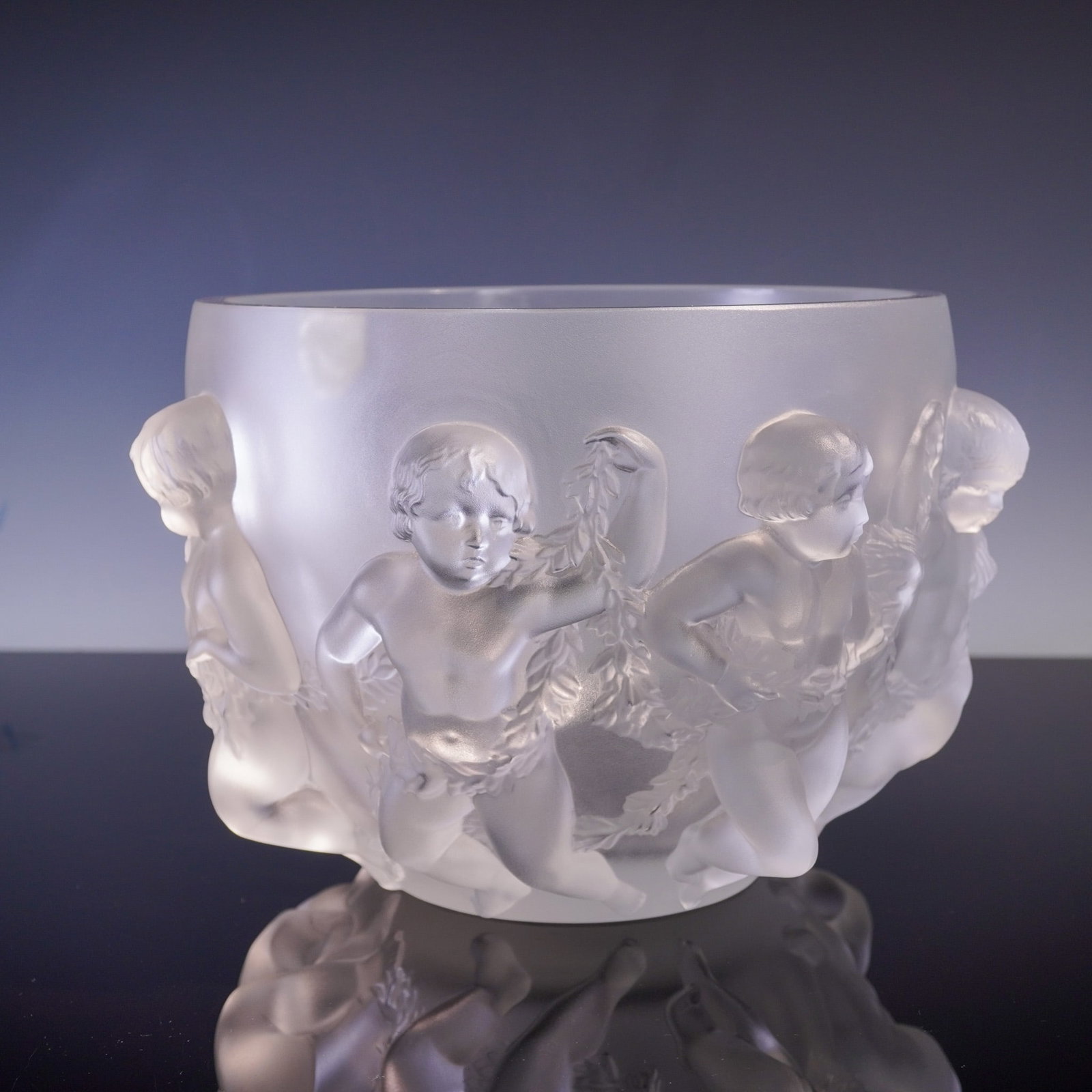 Lalique Crystal Figurative Bowl, Luxembourg Design: Crafted by the esteemed French crystal house Lalique, this stunning frosted crystal bowl is known as the Luxembourg design, featuring an encircling procession of exquisitely sculpted cherubs in high r
