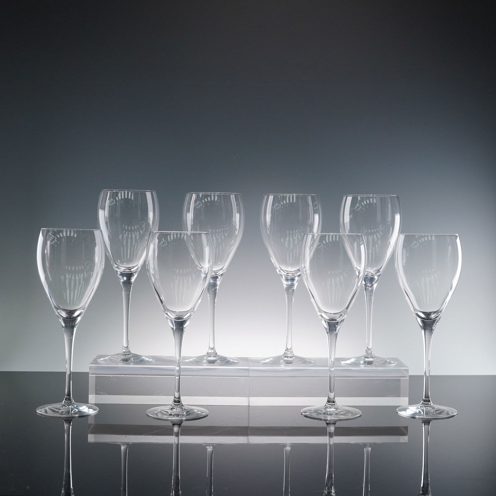 8pc Christofle Albi Wine Glasses: Set of eight Christofle Albi wine glasses, crafted in fine clear crystal with elongated bowls and slender stems. Each glass features the elegant vertical fluting characteristic of the Albi pattern and