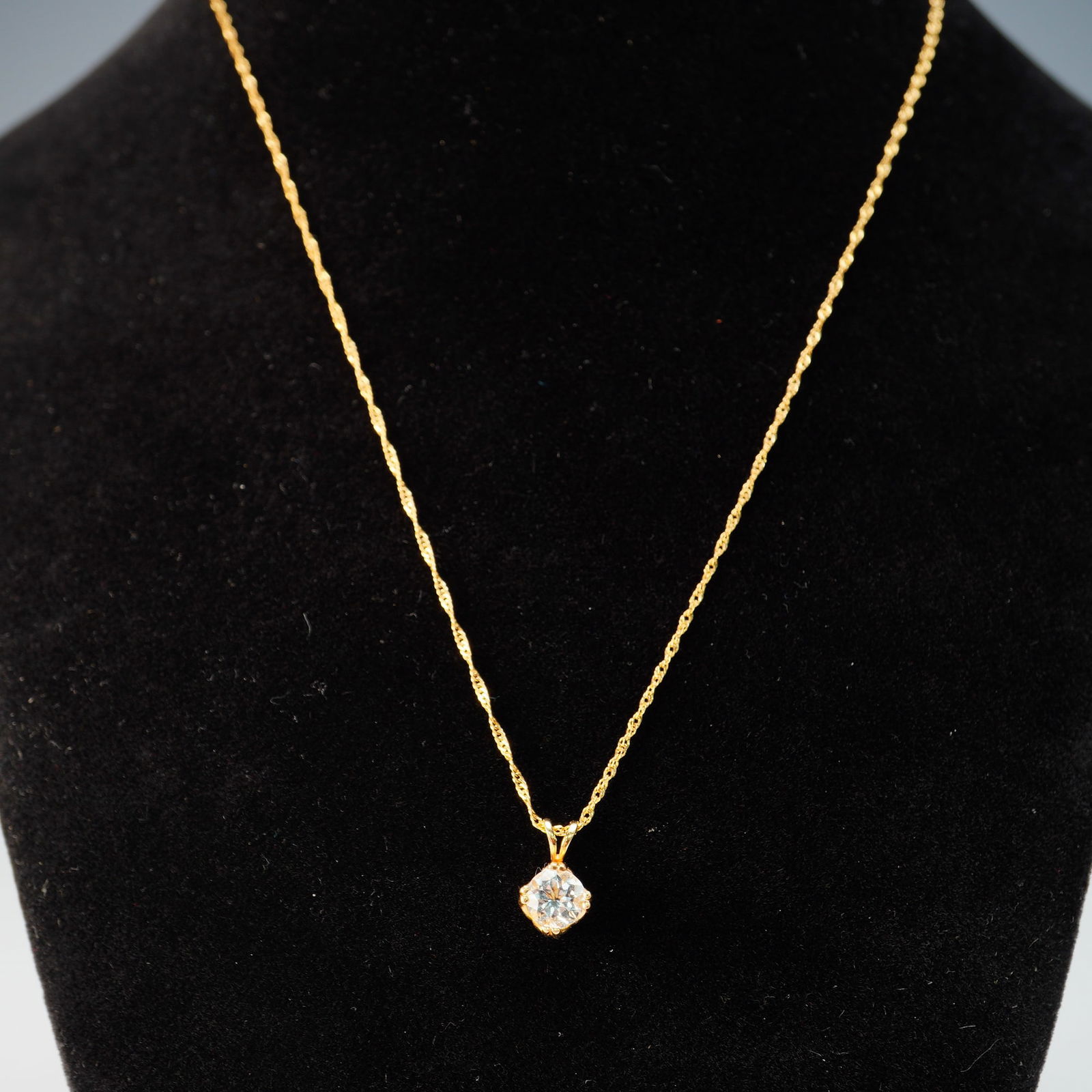 14k Gold Pendant Necklace with Stone: A refined 14k yellow gold pendant necklace featuring a bright, brilliant-cut stone prong-set in a sculptural claw-style mount. The pendant hangs from a fine, twisted rope chain secured with a spring r