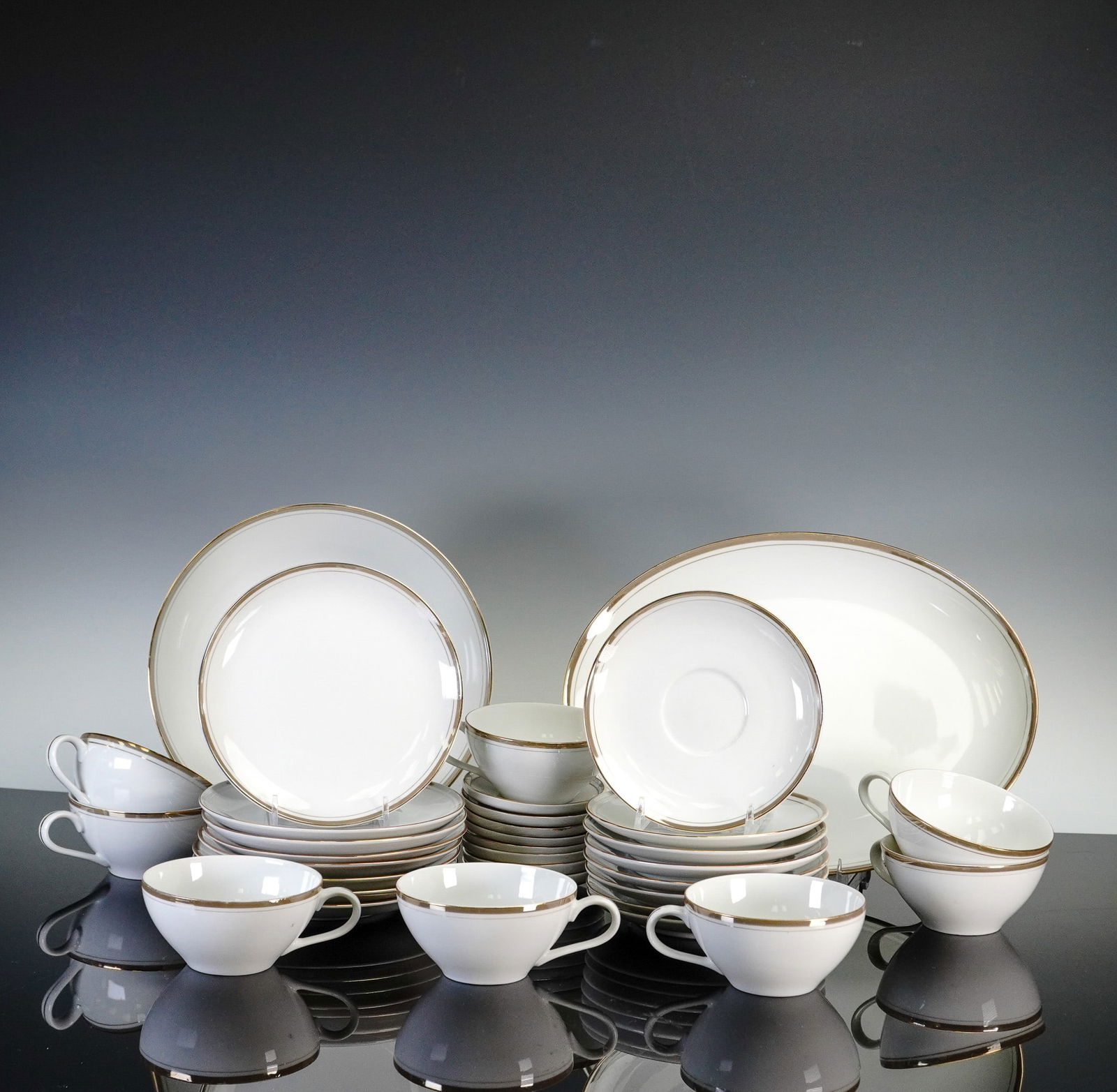 34pc Royalton China Co. Fine China Dinnerware: This elegant 34-piece dinnerware set by Royalton China Co. features classic translucent porcelain crafted in Japan, known for its refined design and gold-rimmed edges. The set includes 8 dessert plate