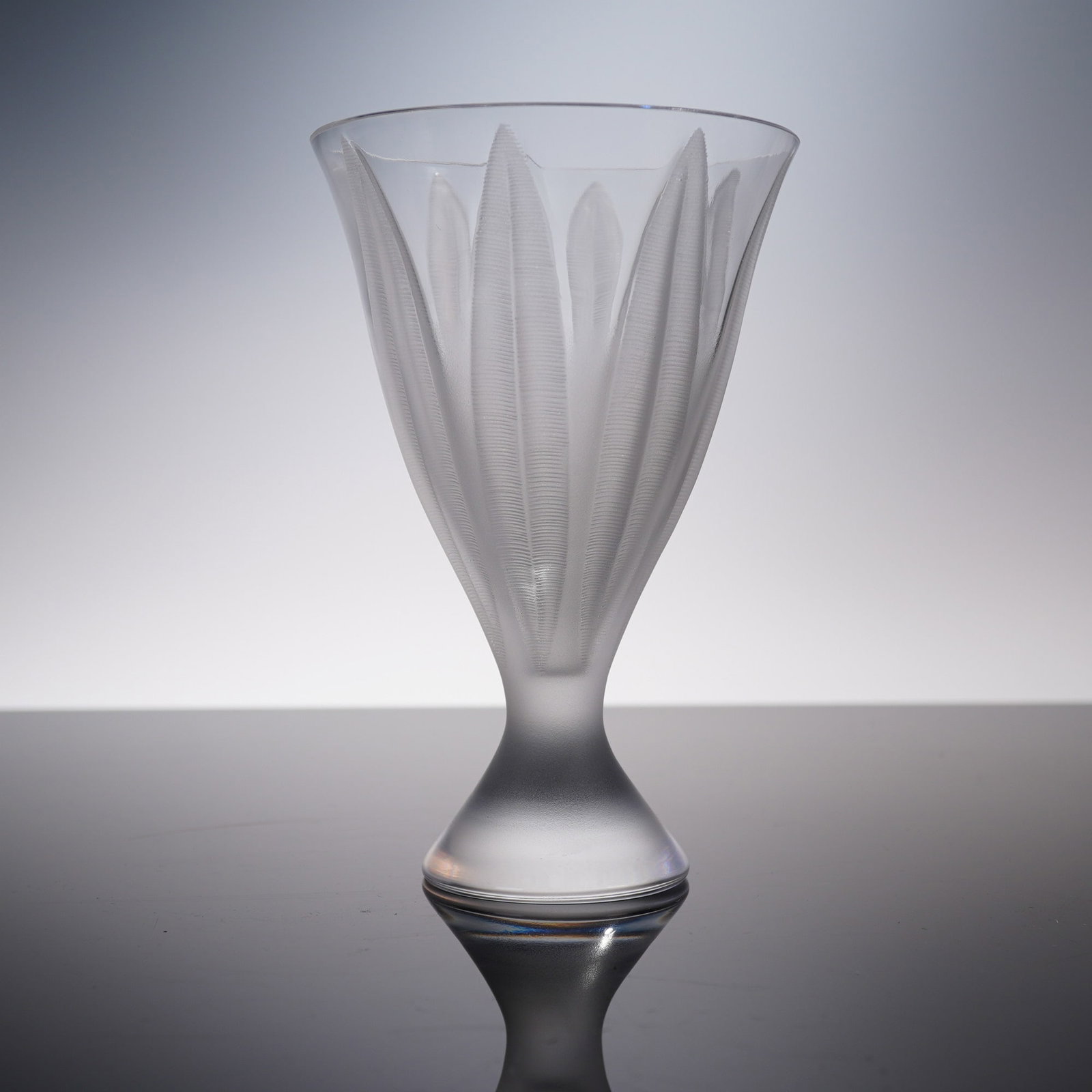 Lalique Frosted Crystal Flower Vase, Campanule: A French Lalique frosted crystal vase in the "Campanule" pattern, featuring an elegant flared form adorned with stylized bellflower petal reliefs. The alternating satin-finished and clear glass elemen