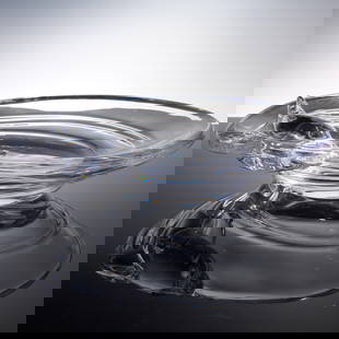 Daum Crystal Dolphin Bowl: A captivating Daum crystal bowl showcasing a high relief dolphin leaping along the rim. Expertly formed from clear crystal the bowl features smooth curves and a brilliant finish that reflects light be