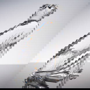 Swarovski Crystal Figurine, Cheetah with High Tail: A striking Swarovski crystal figurine modeled as a seated cheetah, featuring a sleek, faceted body and high, curved tail. The animal's expressive face is delicately sculpted with contrasting smooth an