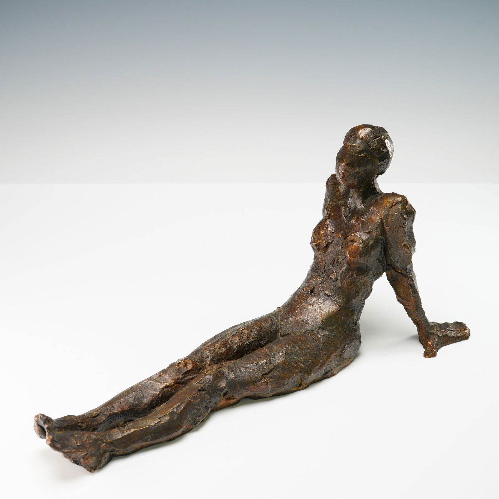 Curt Brill Bronze Figurative Sculpture, Seated Nude 1995: A powerful bronze sculpture by Curt Brill, this piece features a seated nude female figure captured mid-stretch, her posture exuding calm strength and inward reflection. With bold, impressionistic tex