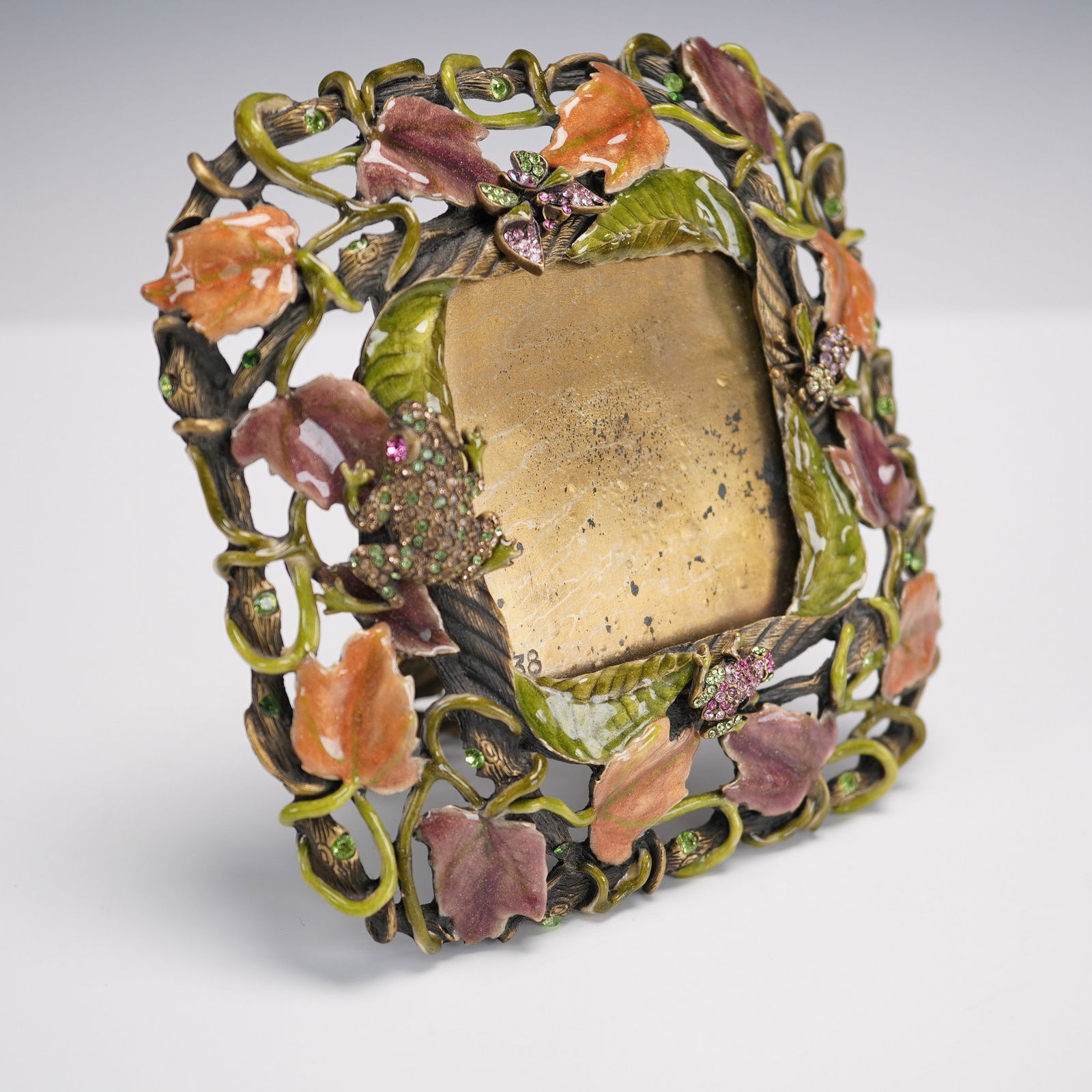Jay Strongwater Jeweled Garden Picture Frame: Jay Strongwater enamel and jeweled picture frame styled as an garden scene, featuring hand painted vines and autumnal leaves, winding through a sculptural openwork border adorned with sparkling crysta