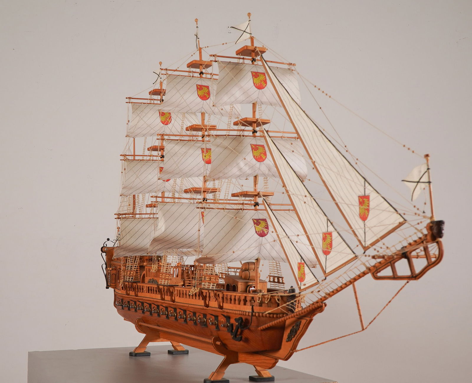 Grand Handcrafted Wood 1.28 Scale Model 17th Century Galleon Warship & Case: This meticulously handcrafted wooden model replicates the grandeur of a 17th-century European galleon, complete with three towering masts, a full array of cloth sails, and a row of side-mounted cannon