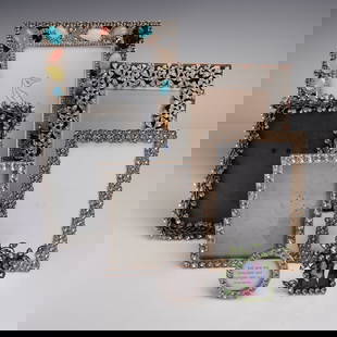 7pc Rhinestone and Crystal Embellished Picture Frames: A group of seven rhinestone and crystal embellished picture frames, ranging in height from approximately 3 inches to 9 inches. This elegant collection includes a variety of ornate styles, such as a vi