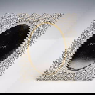 Jay Strongwater Jeweled Picture Frame: Jay Strongwater jeweled picture frame, model SPF 5190, featuring an ornate silver tone openwork border set with sparkling clear crystals, centered around an oval panel of swirled amber enamel with a h