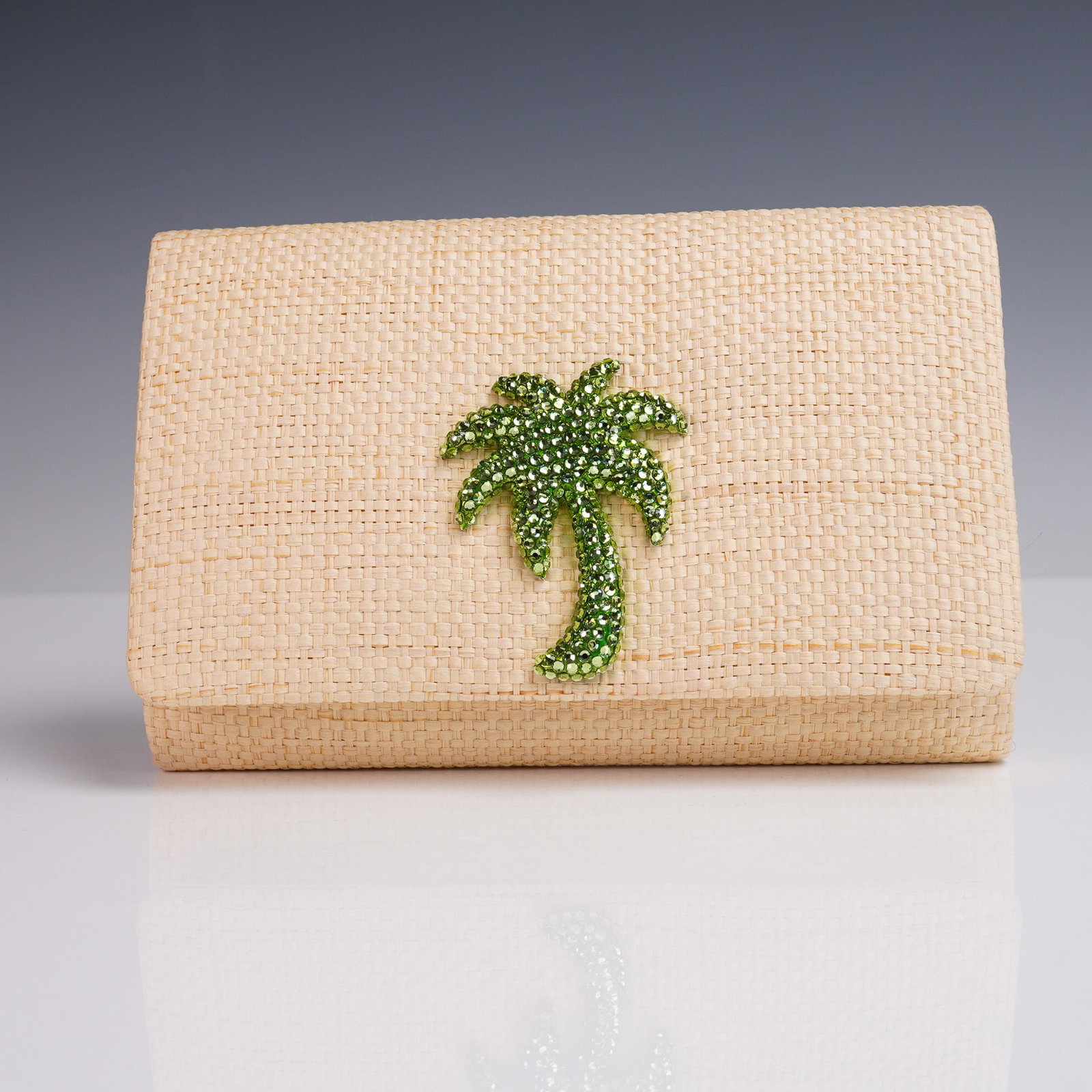 Eliza Gray Palm Tree Crystal Straw Clutch Purse with Chain: This charming clutch by Eliza Gray features a natural woven straw exterior adorned with a vibrant green rhinestone crystal palm tree motif, lending a whimsical tropical flair. The structured rectangul