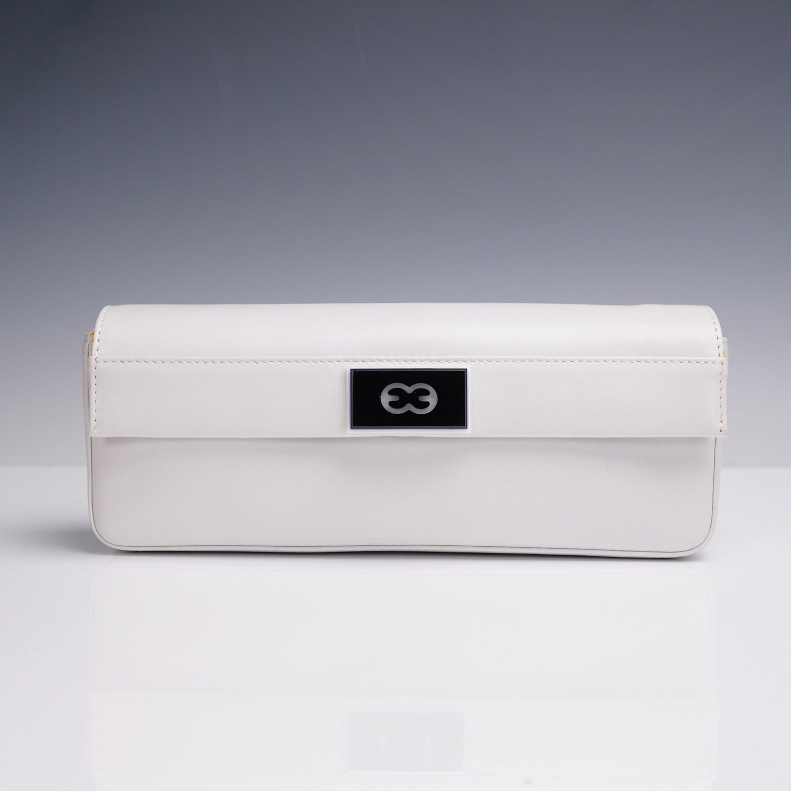 Escada White Leather Mini Shoulder Bag: Sophisticated shoulder bag in sleek white leather featuring a fold-over flap with the brand's signature black and silver logo accent. The bag includes a striking silver-tone chain strap interlinked wi