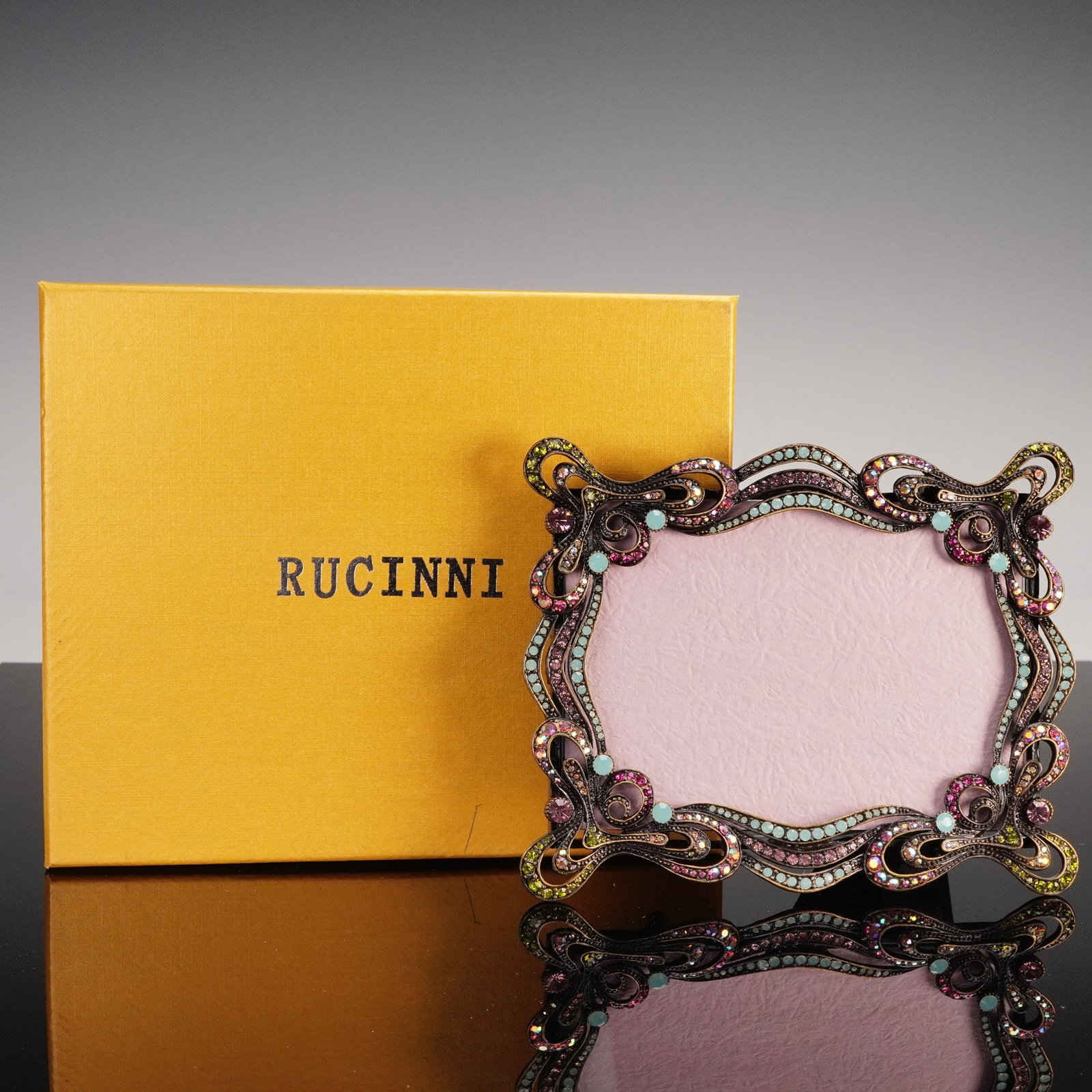 Rucinni Jeweled Metal & Crystal Picture Frame: A dazzling and decorative picture frame by Rucinni, renowned for its collectible jeweled objects d'art. This ornate frame features a sinuous Art Nouveau-inspired silhouette with swirling openwork flou