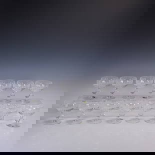 13pc Waterford Crystal Maureen Cut Champagne/Tall Sherbet Glasses: A 13-piece set of Waterford crystal champagne/tall sherbet glasses in the Maureen cut pattern. These glasses feature rounded bowls with deep vertical fluting and are elevated on short, baluster-style