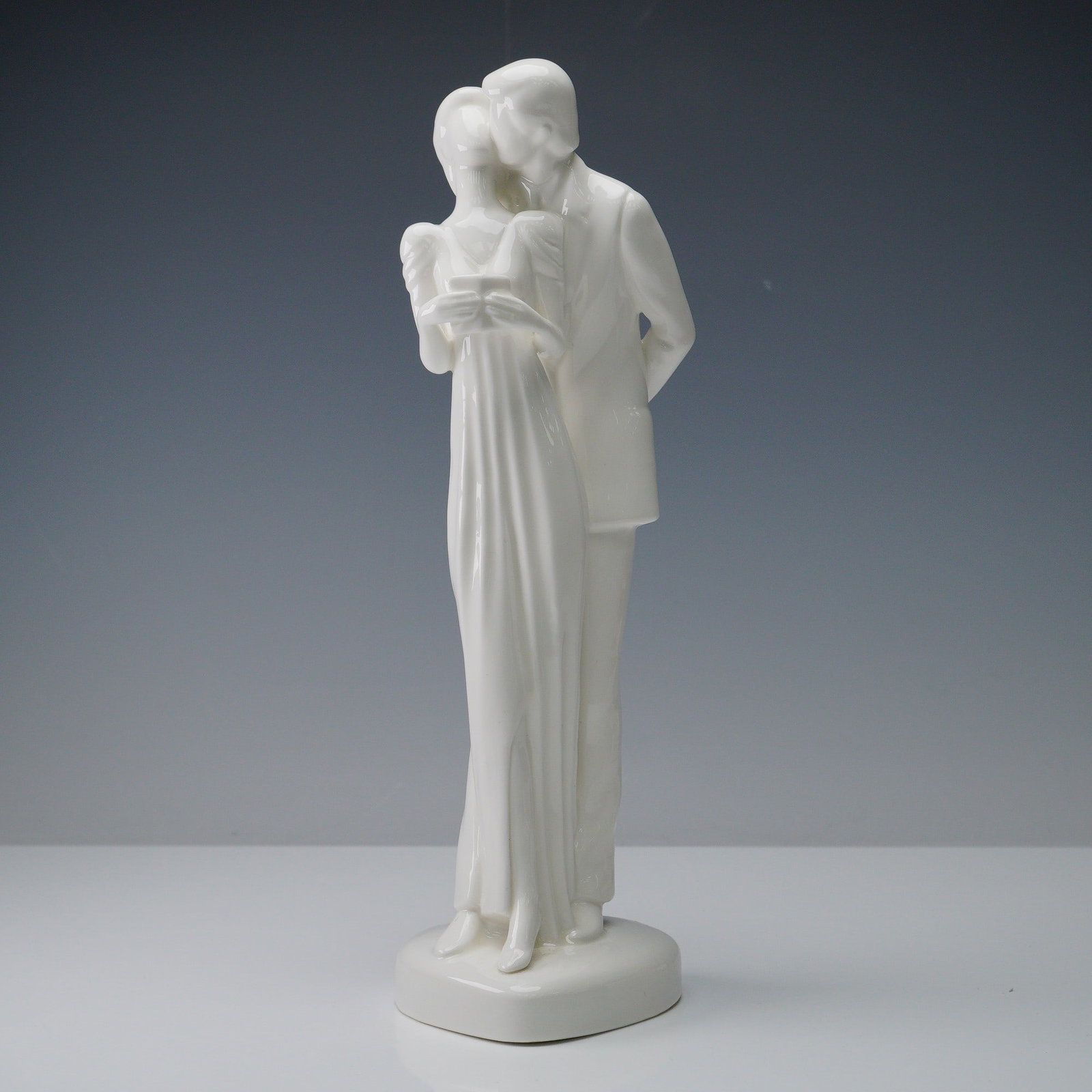 Royal Doulton Figurine, Images HN3254: Beautiful white porcelain figurine that captures a graceful and romantic moment between a couple locked in a celebratory embrace. This piece emphasizes sentiment through minimalist design. Royal Doult