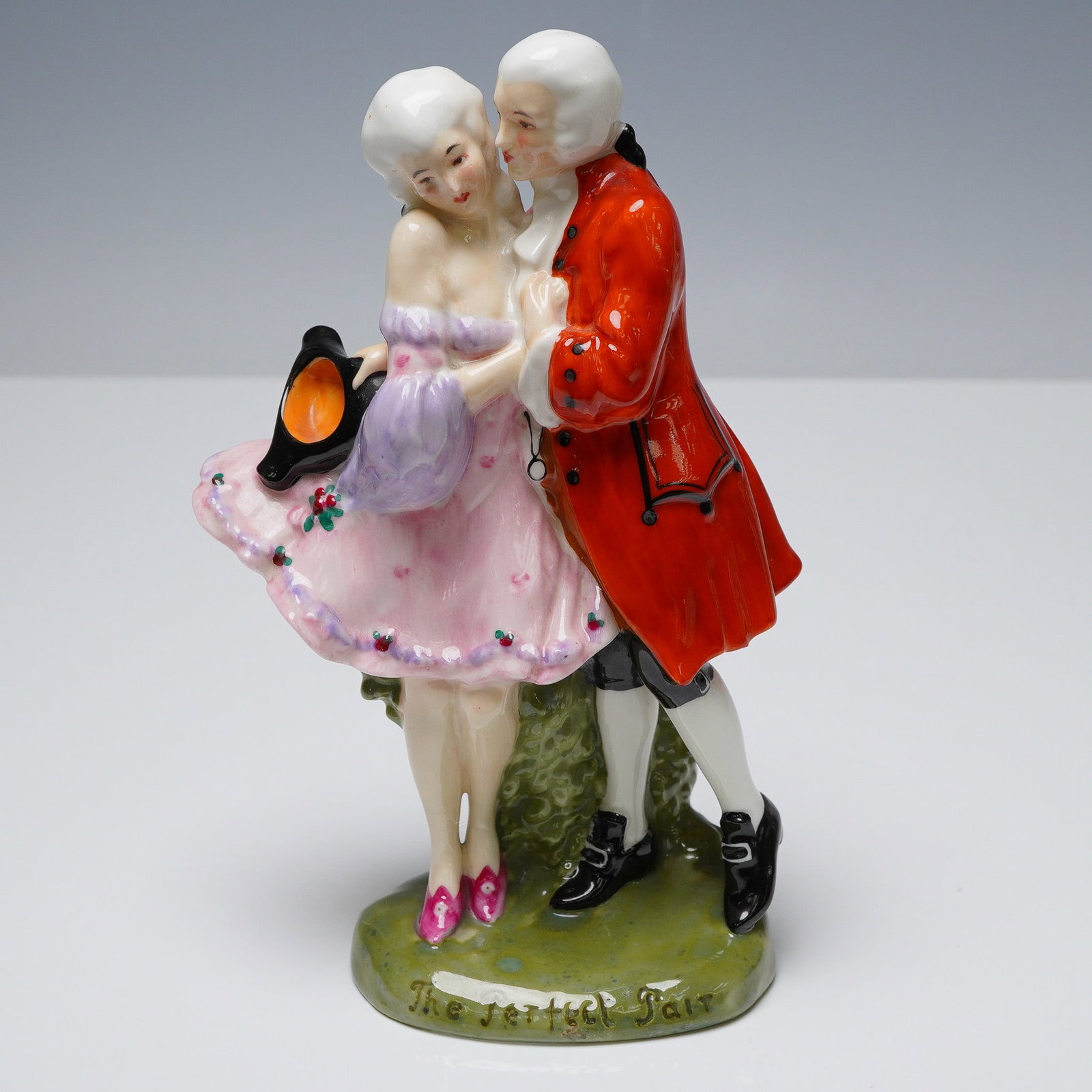 Royal Doulton Figurine, The Perfect Pair HN581: Radiating timeless romance and theatrical charm, this Royal Doulton figurine titled The Perfect Pair HN581 captures a spirited 18th century couple frozen in a graceful intimate moment. The dashing gen