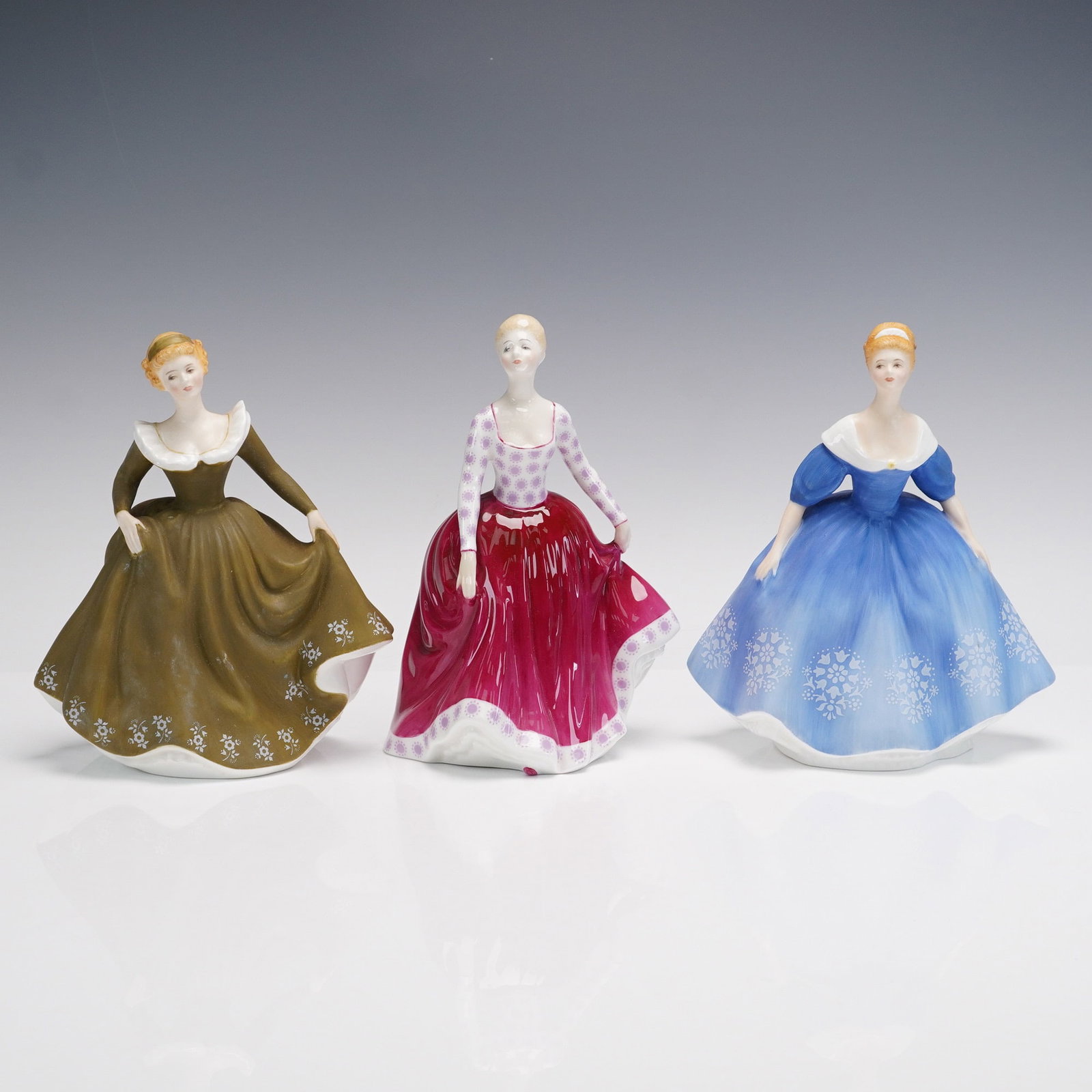 3pc Royal Doulton Porcelain Figurines, Nina Fiona Geraldine: Charming trio of Royal Doulton porcelain figurines including Nina HN2347 (1968), Fiona HN2694 (1973), and Geraldine HN2348 (1971), each beautifully hand-painted and marked on the base with the Royal D