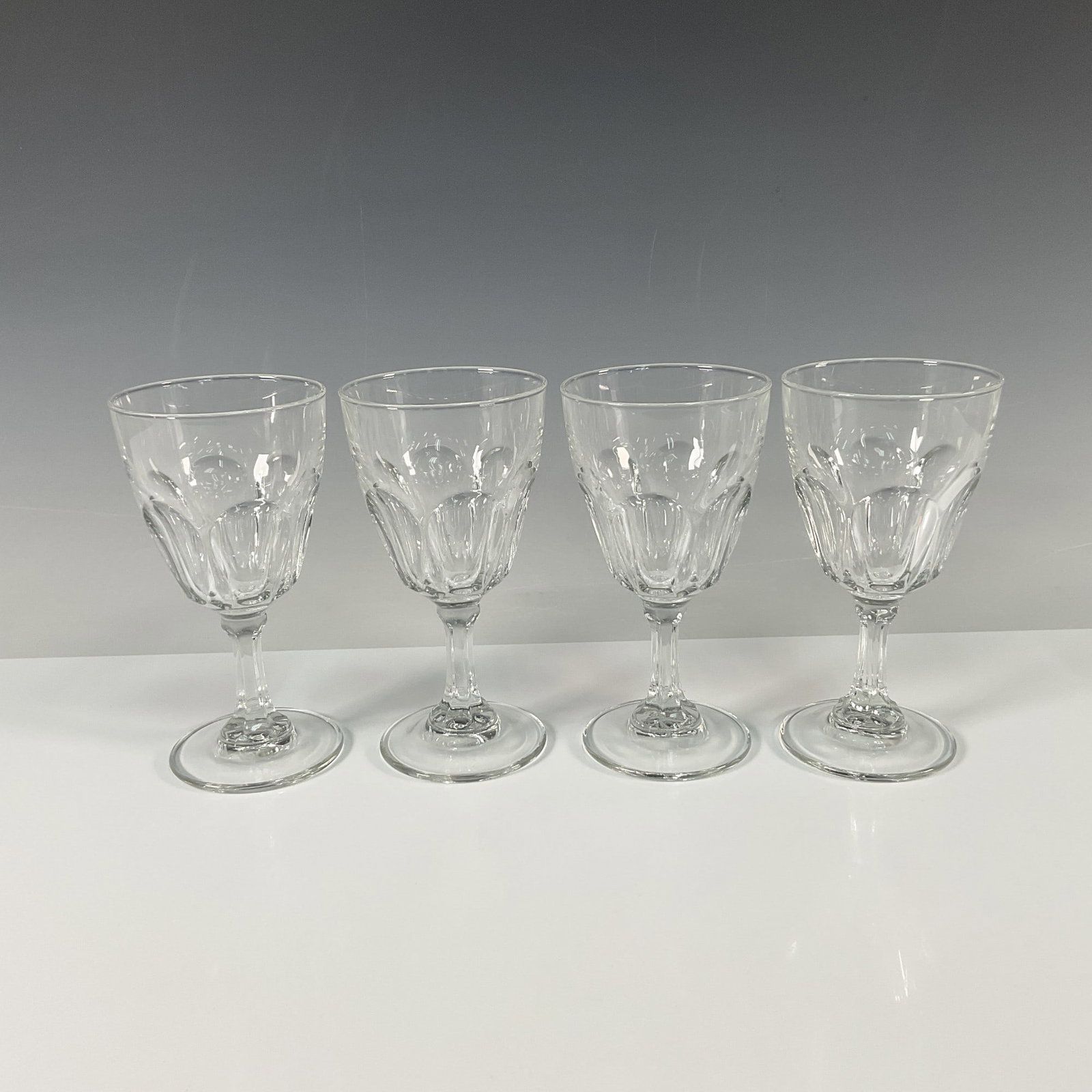 4pc Arcoroc Crystal Wine Glasses: This set of four Arcoroc wine glasses features an elegant design with a 6.5" height. The glasses are marked with the embossed backstamp "Arcoroc, France" on the base, confirming their French origin. A