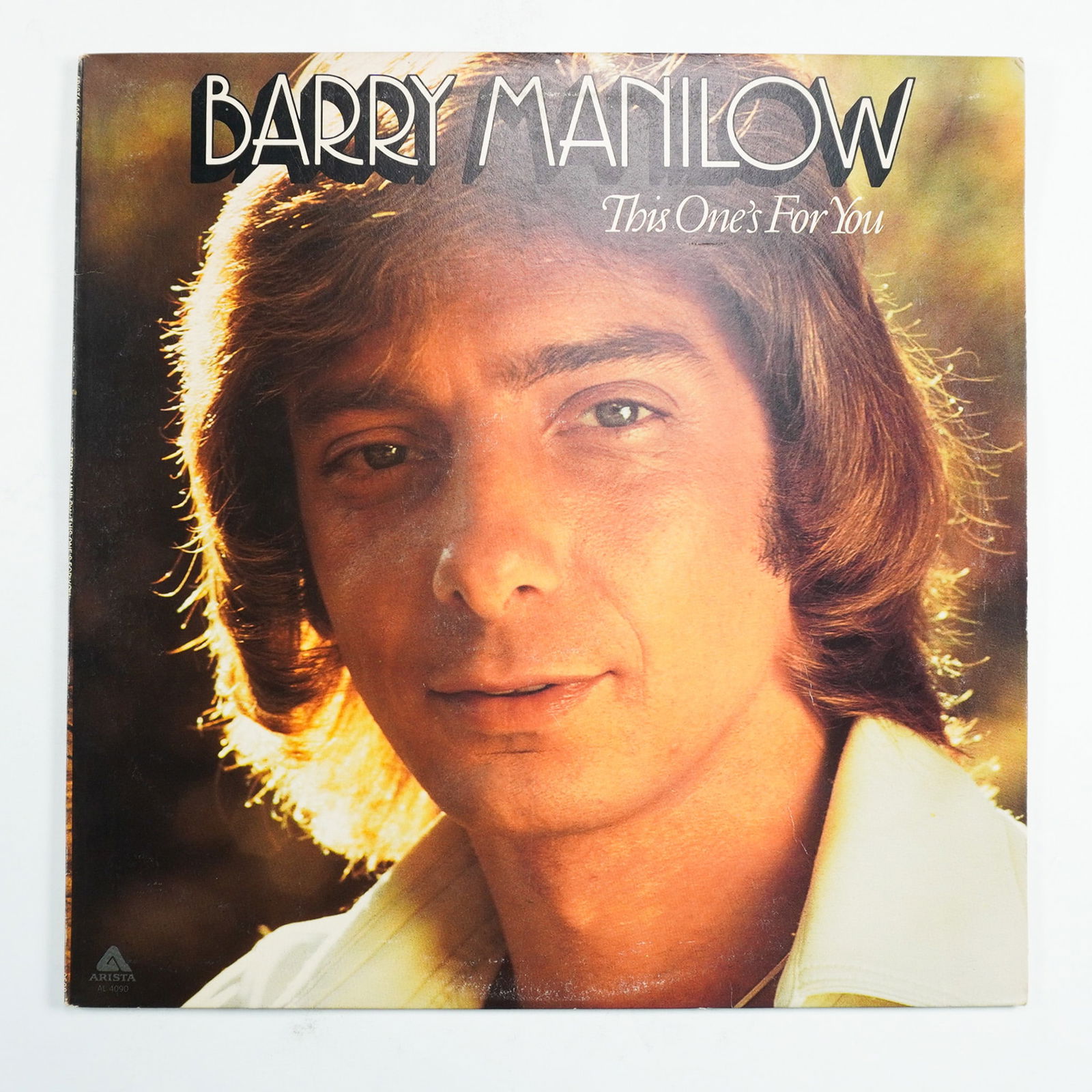 Barry Manilow, This One's For You Vinyl LP, Arista Records: Barry Manilow's This One's For You is a classic 1976 vinyl LP released by Arista Records, featuring hits like "This One's For You" and "Weekend in New England." Produced by Ron Dante and Manilow, this